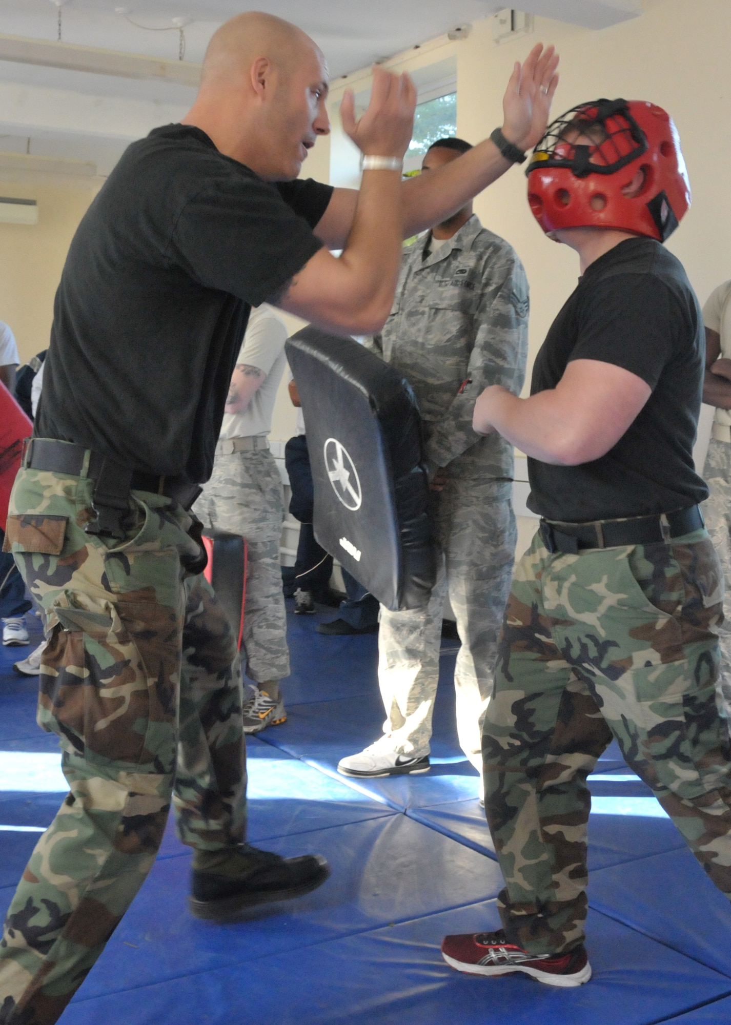 ROYAL AIR FORCE LAKENHEATH, England – Staff Sgt. Michael White (left), 48th Security Forces Squadron Instructor, demonstrates hand strikes to Senior Airman Ricky Kranning, 48th Civil Engineer Squadron Heating, Ventilating and Air Conditioning journeyman, during security forces augmentee training, Sept. 30 at RAF Fetwell. The augmentees will help with manning for the Security Forces Squadron during high Force Protection Condition levels.  This is the first augmentee program initiated for RAFs Lakenheath and Feltwell.  (U.S. Air Force photo/Staff Sgt. Connor Estes)