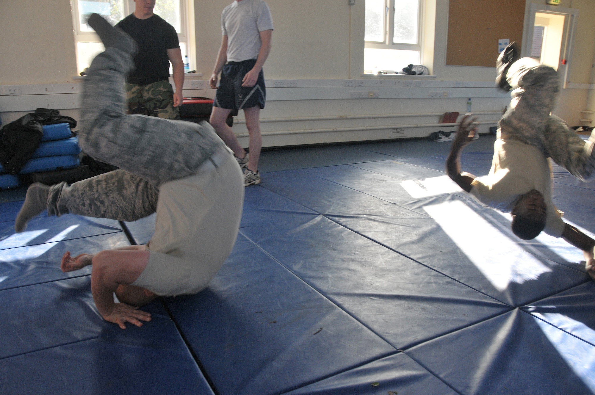 ROYAL AIR FORCE LAKENHEATH, England – Staff Sgt. Robert Rice (left), 48th Medical Group NCO in Charge of purchasing, and Airman 1st Class Jeramie Green, 48th Aerospace Medicine Squadron Bioenvironmental Engineering technician, practice falling techniques during security forces augmentee training, Sept. 30 at RAF Fetwell. This is the first augmentee program for RAFs Lakenheath and Feltwell.  The augmentee program was initiated to help cover austere manning for the Security Forces Squadron during high Force Protection Condition levels.  (U.S. Air Force photo/Staff Sgt. Connor Estes)