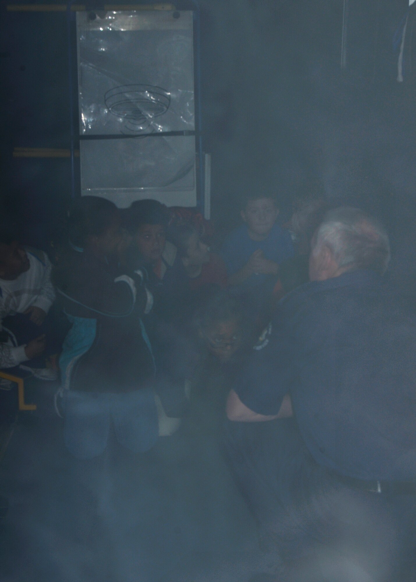 ROYAL AIR FORCE LAKENHEATH England - Community Fire Safety Officer John Clouting of the Suffolk Fire and Rescue Service Fire Experience Unit, (right), briefs a group of RAF Lakenheath Intermediate School students on safety procedures during a simulated bedroom fire as part of National Fire Prevention Week on Oct. 5. Opening the window to shout for help, getting down on the ground and banging on floor to let the arriving help know where they were and other instructions were given to the students during the mock fire. (U.S. Air Force photo/Airman 1st Class Tiffany M. Deuel)
