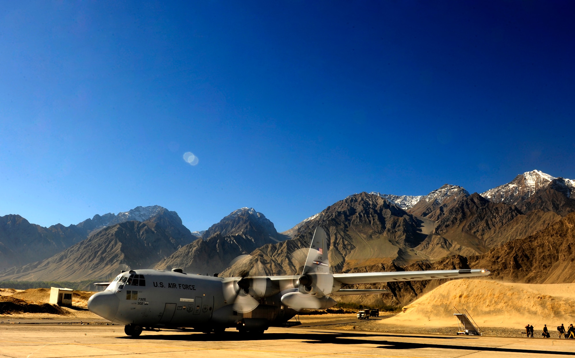 A U.S. Air Force C-130 is positioned to unload humanitarian aid supplies Oct. 3 at Skardu airfield, Pakistan. U.S. military aircraft, working in close coordination with the Pakistan military, have transported more than 6.6 million kilograms of relief supplies and evacuated 21,000 people in the flood-affected regions of Pakistan during the last two months. Although the cargo aircraft flights have ended, U.S. commitment to supporting Pakistan’s flood relief efforts remains strong. In addition to continuing relief flights by U.S. military helicopters, the U.S. Agency for International Development and other U.S. civilian agencies continue to provide humanitarian assistance and recovery assistance throughout Pakistan in support of flood victims. (Photo by U.S. Air Force Staff Sgt. Andy Kin)