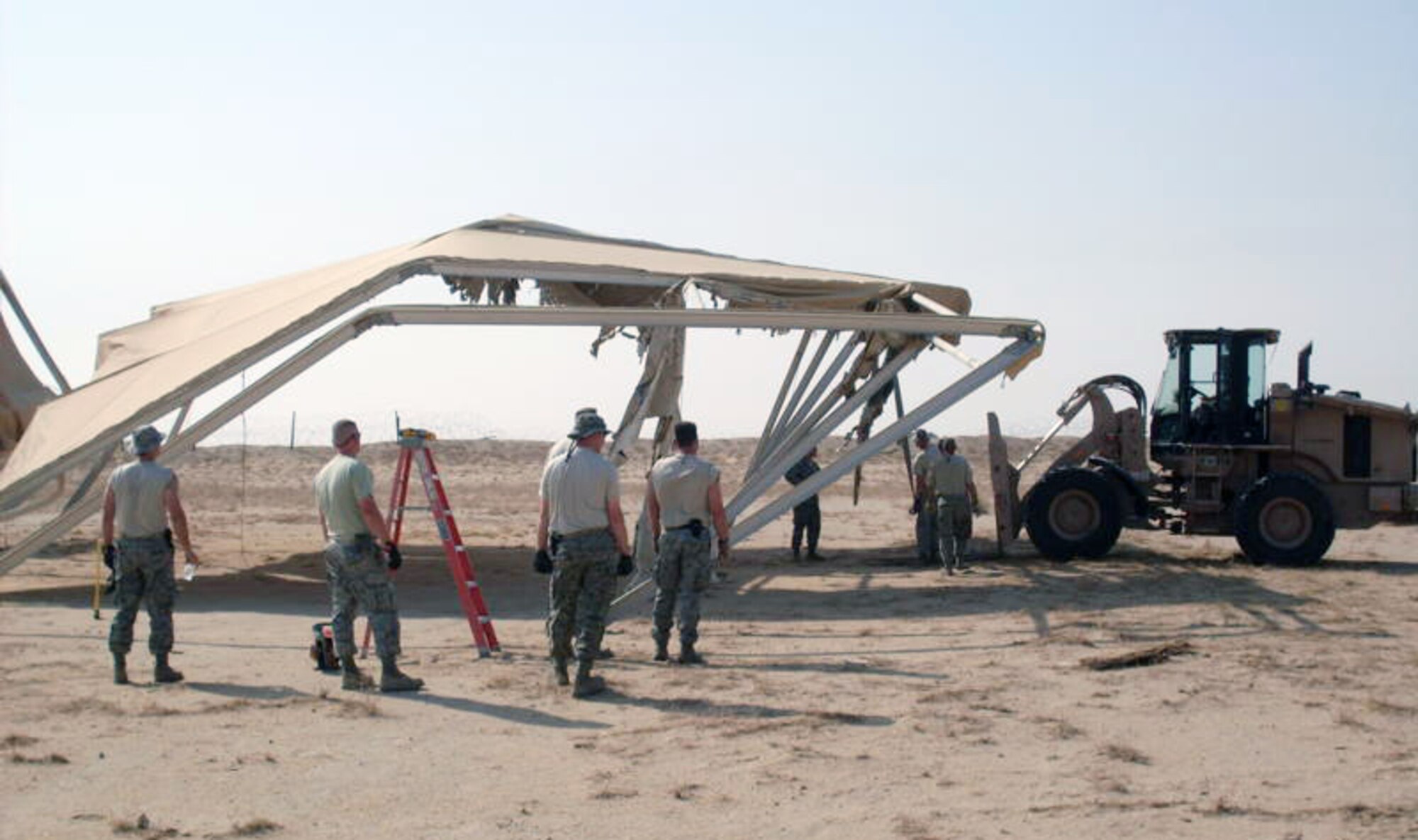 SOUTHWEST ASIA - Airmen from the 386th Expeditionary Civil Engineer Squadron demolish sunshades at an undisclosed air base Sept. 2, 2010. Over 9,470 pounds of scrap metal with a value of more than $4,700 were collected during the tear-down, contributing substantially to the base recycling program here. (U.S. Air Force photo courtesy of 386th ECES)