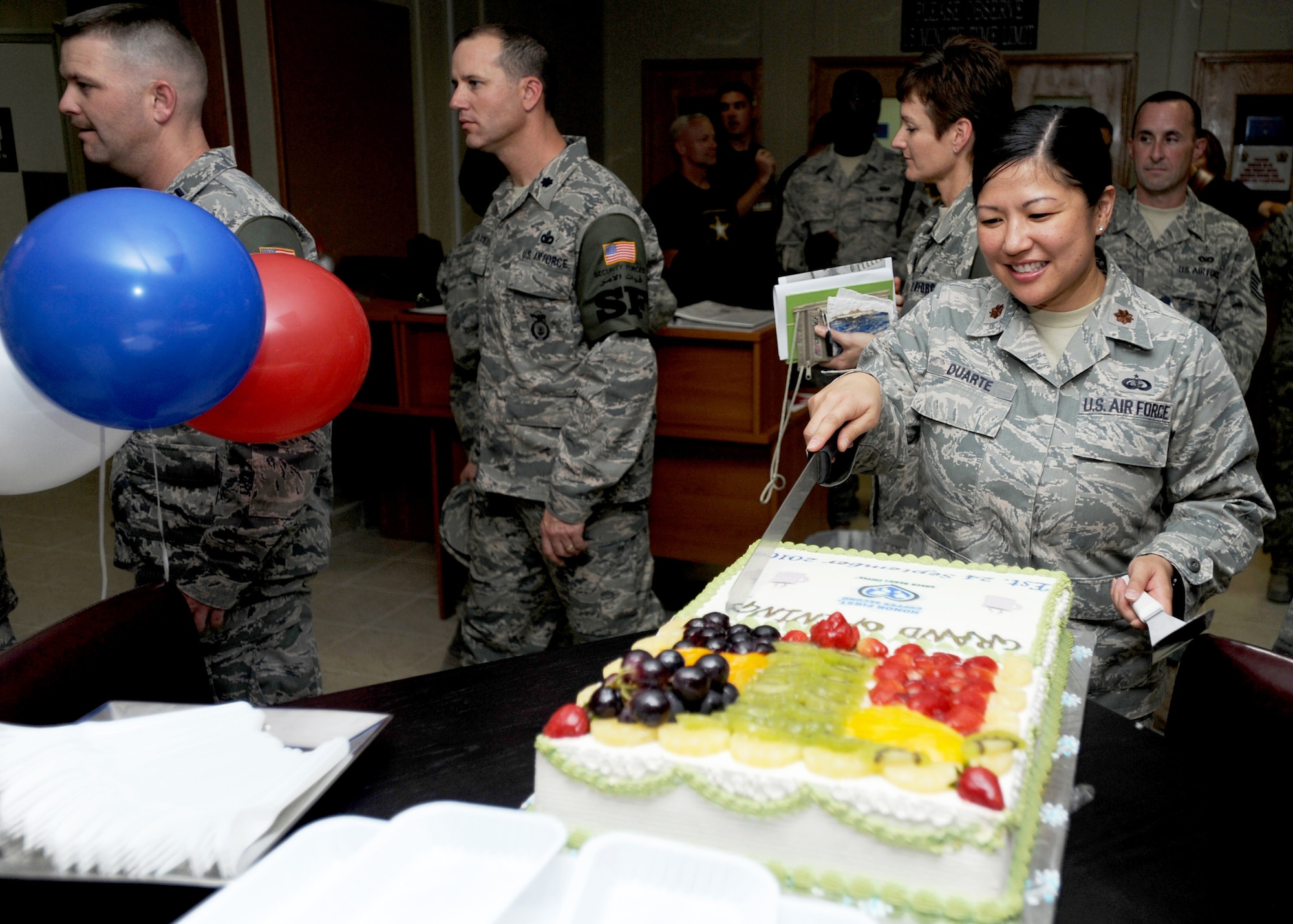 SOUTHWEST ASIA - Maj. Rosalie Duarte, 386th Expeditionary Force Support Squadron commander, cuts a cake to celebrate the grand opening of a new coffee bistro at an undisclosed air base here Sept. 24, 2010. The bistro is located in the Oasis Morale Center, which offers free Internet access and comfortable surroundings. (U.S. Air Force photo by Senior Airman Laura Turner)