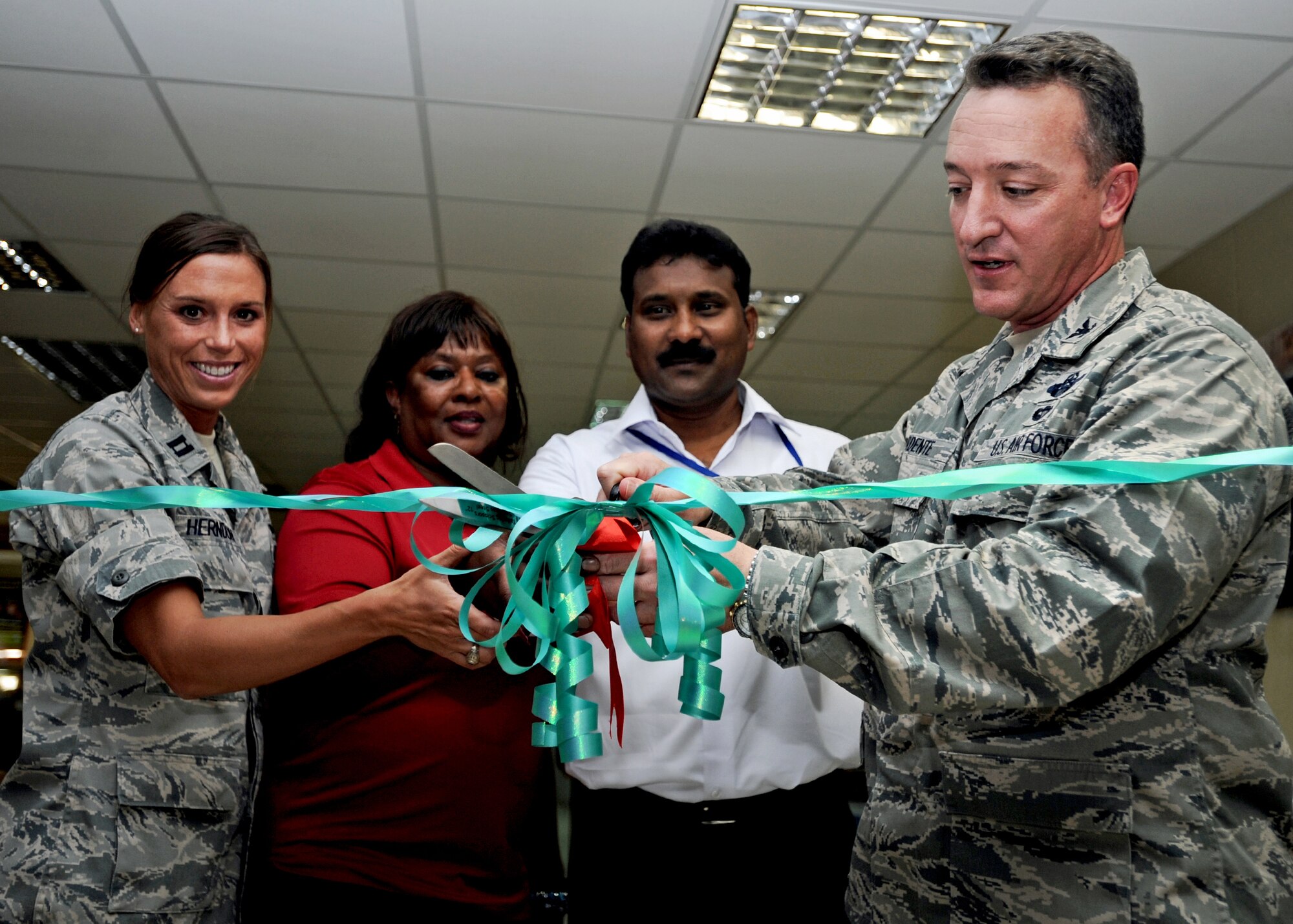 SOUTHWEST ASIA - Col. Patrick Mordente (right), commander of the 386th Air Expeditionary Wing, cuts a ribbon dedicating a new coffee bistro at an undisclosed air base here Sept. 24, 2010. Joining Colonel Mordente are (left to right) Capt. Robin Herndon, 386th Expeditionary Force Support Squadron Community Services Flight commander; Army and Air Force Exchange Service manager Barbara Travis; and Ratna Gollandala, manager of the caf?. The bistro, which offers free Internet access and comfortable surroundings, is located in the Oasis Morale Center. (U.S. Air Force photo by Senior Airman Laura Turner)