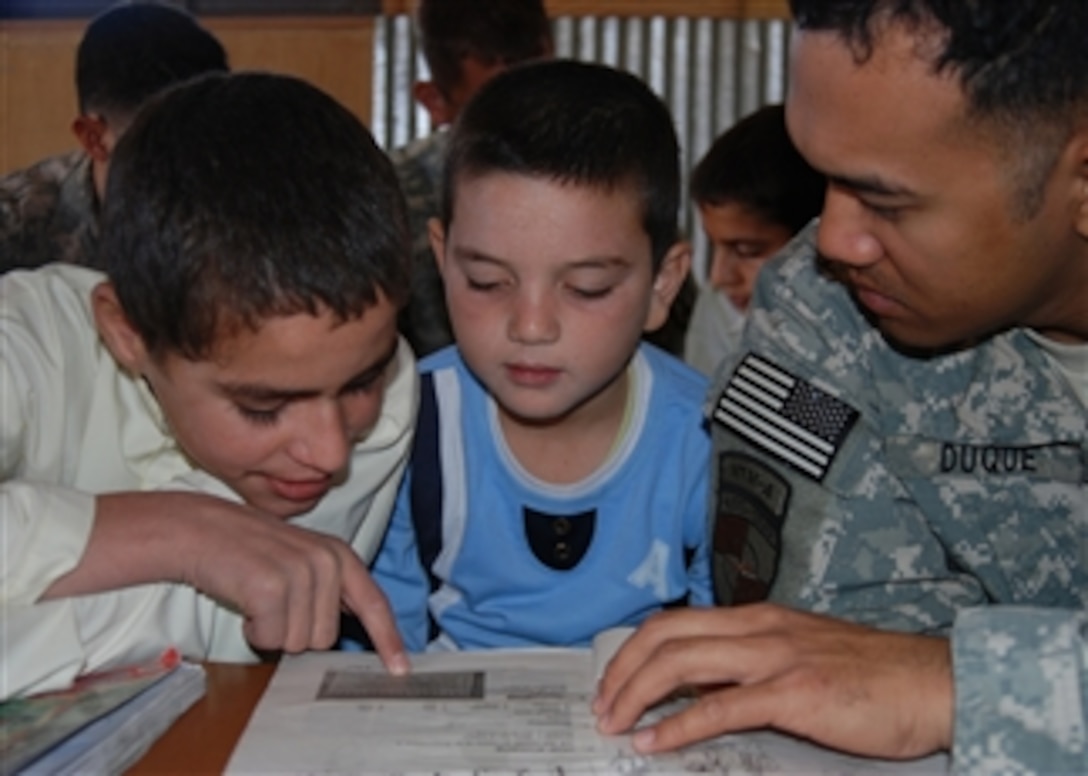 U.S. Navy Petty Officer 1st Class Rodolfo Duqu  (right) practices conversational English with children of Afghan National Army soldiers at Camp Shaheen, Afghanistan, Oct. 3, 2010. Duque is deployed from Naval Branch Health Clinic Bangor, Wash., as a member of NATO Training Mission - Afghanistan's medical embedded training team to assist in the development and training of Afghan soldiers with the 209th Corps Regional Hospital.  