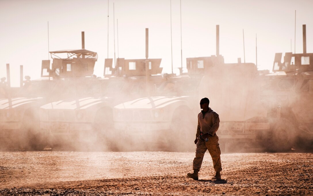 Sgt. Zachary K. Tokomoto, an assistant convoy commander with Headquarters Company, 3rd Battalion, 3rd Marine Regiment, ground guides a vehicle into the motor transportation lot at Forward Operating Base Geronimo, Afghanistan, Oct. 7, 2010. Currently at 93 percent, 3/3 Motor T has the highest vehicle readiness percentage of any infantry battalion in Southern Afghanistan, said Staff Sgt. Justin Johnson, the 3/3 Motor T maintenance chief.
