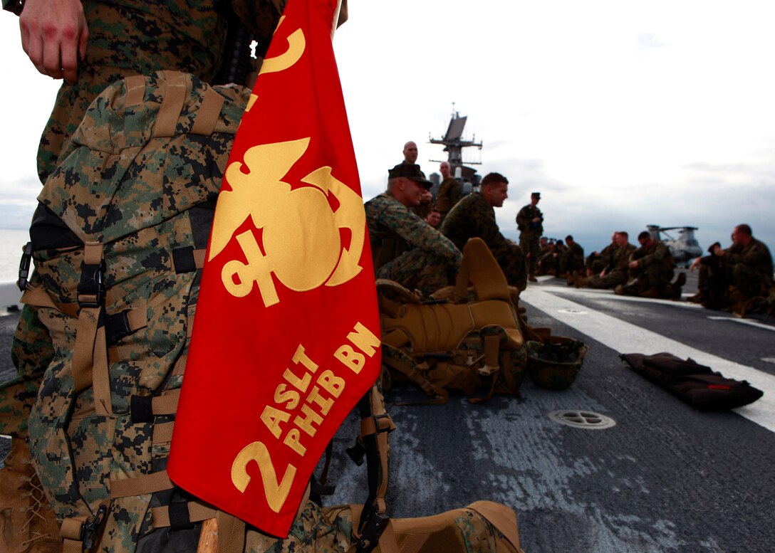 U.S. Marines and Sailors from 2nd Assault Amphibian Battalion, attached to Special-Purpose Marine Air-Ground Task Force Continuing Promise 2010, take a ten-minute break to check gear and clean weapons, while conducting a six mile hump, aboard amphibious assault ship USS Iwo Jima (LHD7), off the coast of Chiriqui Grande, Panama, Oct. 7, 2010. Service members and civilians are deployed in support of CP10 providing medical, dental, veterinary, engineering assistance and subject-matter exchanges to Caribbean, Central and South American nations.