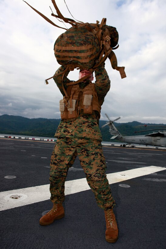 U.S. Marine Sgt. John W. Logan, with Company A, 2nd Assault Amphibian Battalion, attached to Special-Purpose Marine Air-Ground Task Force Continuing Promise 2010, prepares to continue a six mile hump, after taking ten-minute break to check gear and clean weapons, aboard amphibious assault ship USS Iwo Jima (LHD7), off the coast of Chiriqui Grande, Panama, Oct. 7, 2010. Service members and civilians are deployed in support of CP10 providing medical, dental, veterinary, engineering assistance and subject-matter exchanges to Caribbean, Central and South American nations.