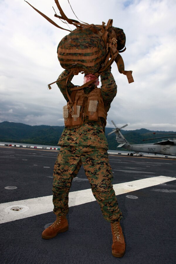 U.S. Marine Sgt. John W. Logan, with Company A, 2nd Assault Amphibian Battalion, attached to Special-Purpose Marine Air-Ground Task Force Continuing Promise 2010, prepares to continue a six mile hump, after taking ten-minute break to check gear and clean weapons, aboard amphibious assault ship USS Iwo Jima (LHD7), off the coast of Chiriqui Grande, Panama, Oct. 7, 2010. Service members and civilians are deployed in support of CP10 providing medical, dental, veterinary, engineering assistance and subject-matter exchanges to Caribbean, Central and South American nations.
