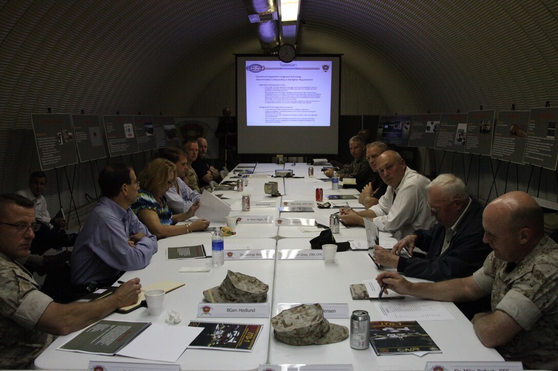 Several scientists, engineers and other military representatives collaborate at Marine Corps Auxiliary Landing Field Bogue Oct. 7, to evaluate a state of the art surveillance demonstration. The technology demonstration occurs annually at Bogue.