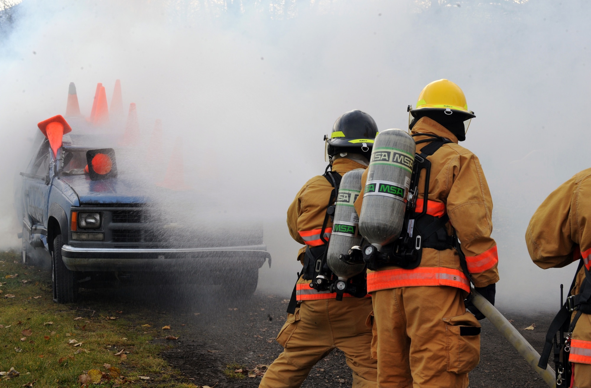 Joint Base Elmendorf-Richardson Fire and Emergency Service firefighters take on a vehicle fire during Force Protection training at Cottonwood Park, Wednesday. (U.S. Air Force photo/Staff Sgt. Joshua Garcia)