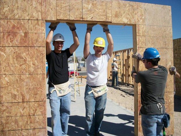 LAS VEGAS--  Staff Sgt. Aaron Iwaniec, Airman 1st Class Brian Claeys, and Staff Sgt. Donald Tomczak raise a wall at the site of their recent volunteer project with Habitat for Humanity. The nonprofit organization has provided more than 1.75 million people in 3,000 communities with safe, decent, affordable shelter through volunteer labor and donations of money and materials. (Courtesy photo)
