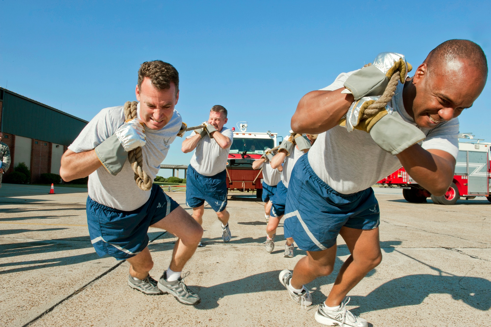 Col. Chad Franks (left), 347th Rescue Group commander, and Col. Neal Robinson, 23rd Maintenance Group commander, lead their team in a P-19 fire truck pull during the annual Fire Prevention Week muster Oct. 4, 2010, at Moody Air Force Base, Ga.  The team completed the pull with a time of 7:38, edging out the 23rd Logistics Readiness Squadron fuels management flight team. (U.S. Air Force photo/Senior Airman Jamal D. Sutter)

