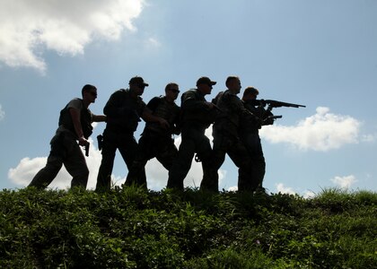 Airmen try out for the Lackland Emergency Services Team Sept. 25. The two-day tryout included a 1-mile run in a gas mask, a six-mile run in full gear, written tests and weapon qualification. (U.S. Air Force photo/Robbin Cresswell)