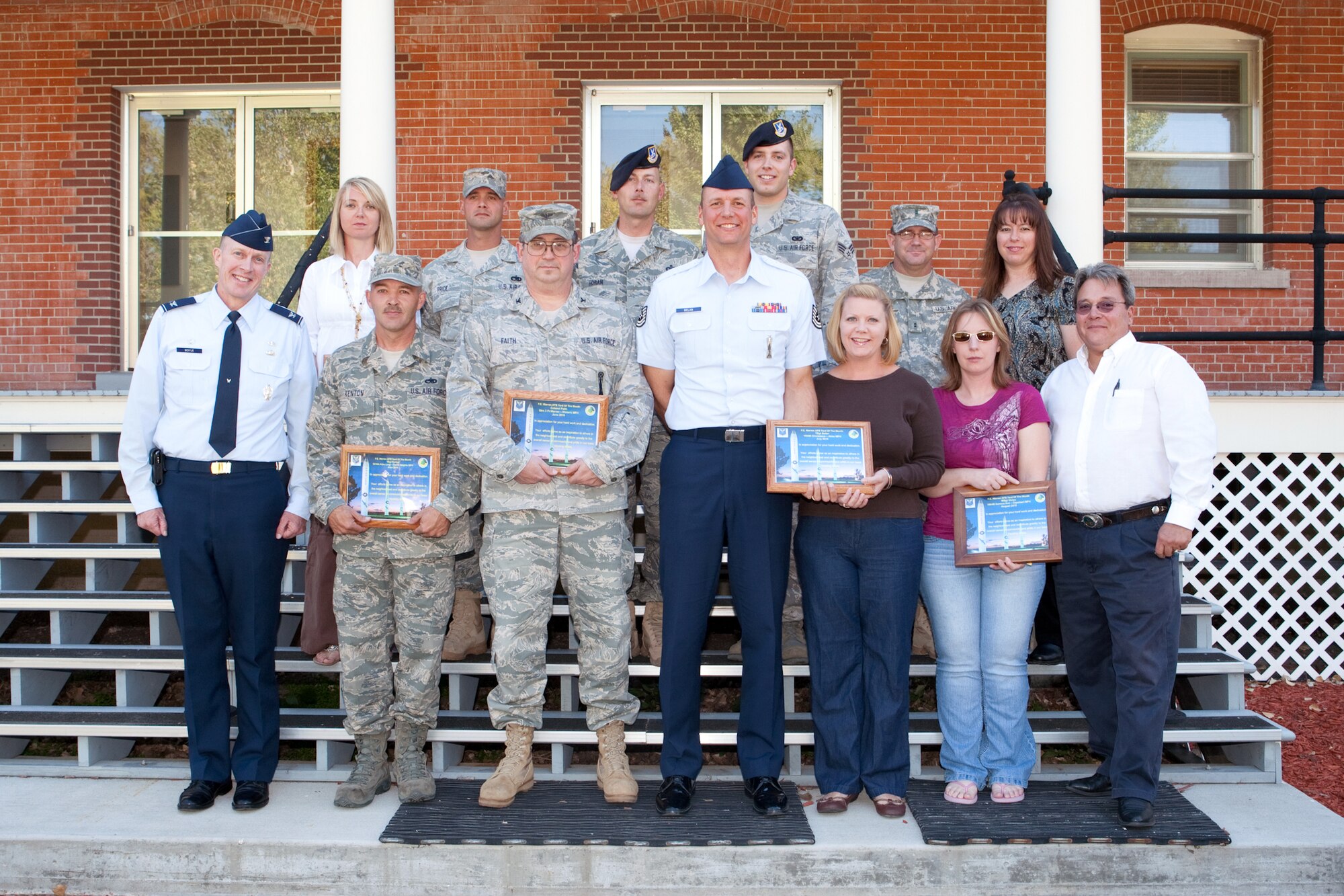 Colonel Sean Boyle, 90th Mission Support Group commander, poses with September’s Yard of the Month winners. The winners were, Tech. Sgt. Andrew Kenton, 153rd Command and Control Squadron; Col. Lyman Faith, 20th Air Force; Tech. Sgt. and Mrs. Brian Belan, 20th AF; Rachel Vivian, Edward Golden, Staff Sgt. and Mrs. Brian Price, 90th Operations Group; Master Sgt. Jim Horan, 90th Security Support Squadron; Senior Airman Grant Bishop, 790th Missile Security Forces Squadron; and Army Chief Warrant Officer 2nd Class and Mrs. Jerry Roberts. (U.S. Air Force photo by Jeff Allred)