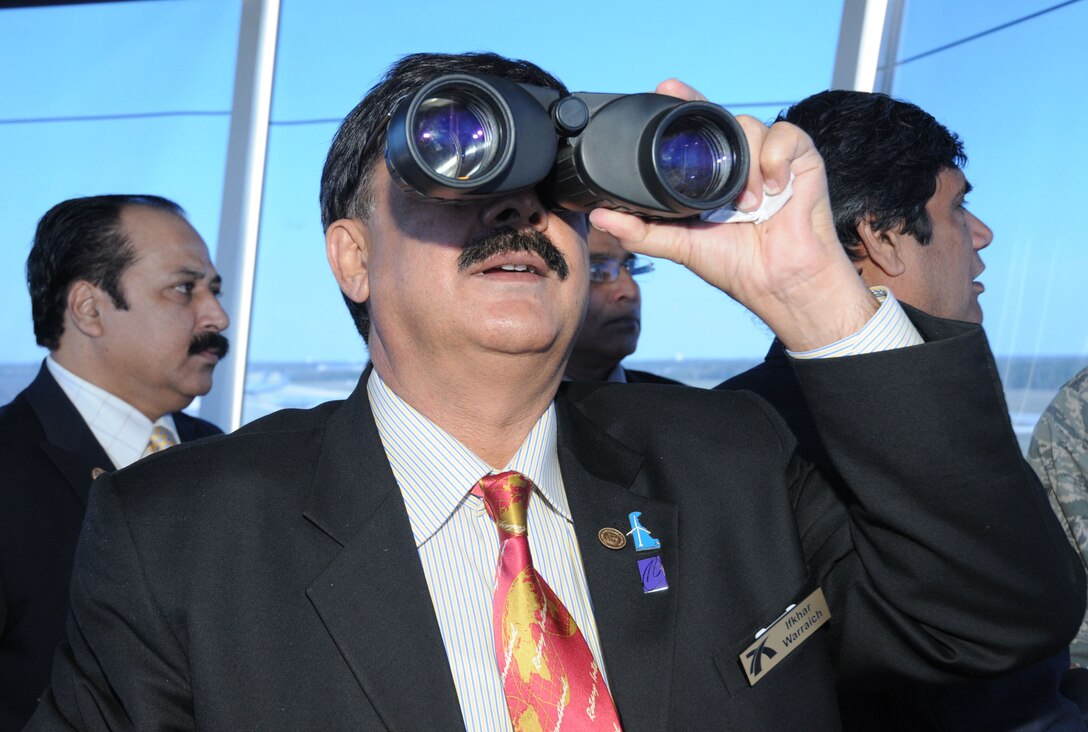 Dr. Ifkhar Hussain Warraich, chief pathologist, Data Darbara Hospital in Lahore, Pakistan, uses binoculars to view the arrival of a C-5 Galaxy from the air traffic control tower at Dover Air Force Base, Del., Oct. 7, 2010. The doctor was one of seven members with the Lahore Mozang Rotary Club in Lahore, Pakistan, who toured the base. The group's nine-day visit to the United States is part of an international exchange program with the Wilmington, Del., Rotary Club. (U.S. Air Force photo by Capt. Marnee A.C. Losurdo/Released)