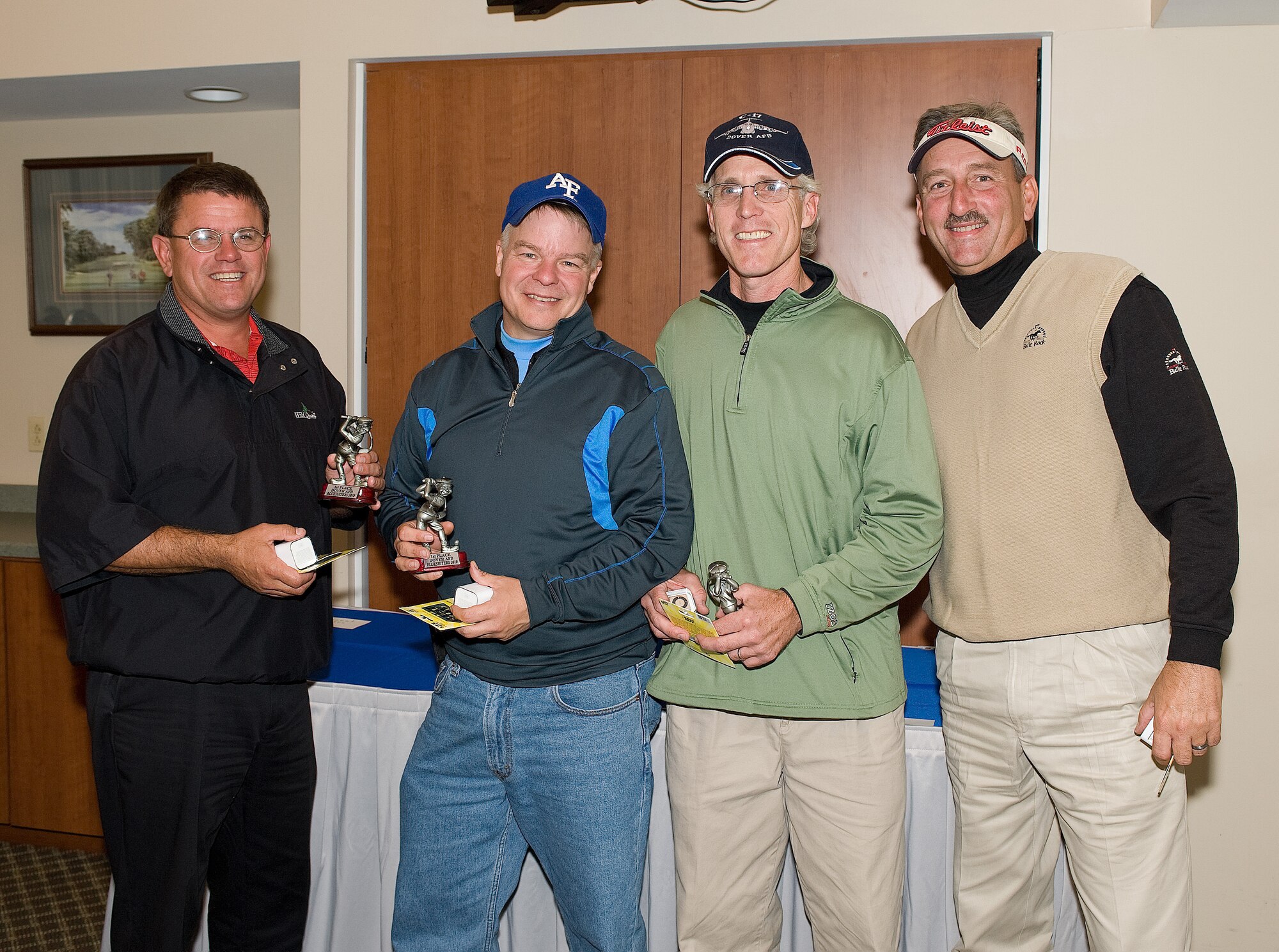 The first place winners of the Bluesuiters' Golf Tournament show off their trophies at the Eagle Creek Golf Course Oct. 6. From left to right are Steve Hoffstadt, Col. David E. Hafer Jr., 436th Operations Group, Dave Clapp, and Chief Master Sgt. Fred Eason, 512th Aircraft Maintenance Squadron. The annual golf tournament enhances community relationships by pairing civilian and military members together for a day of golf. 