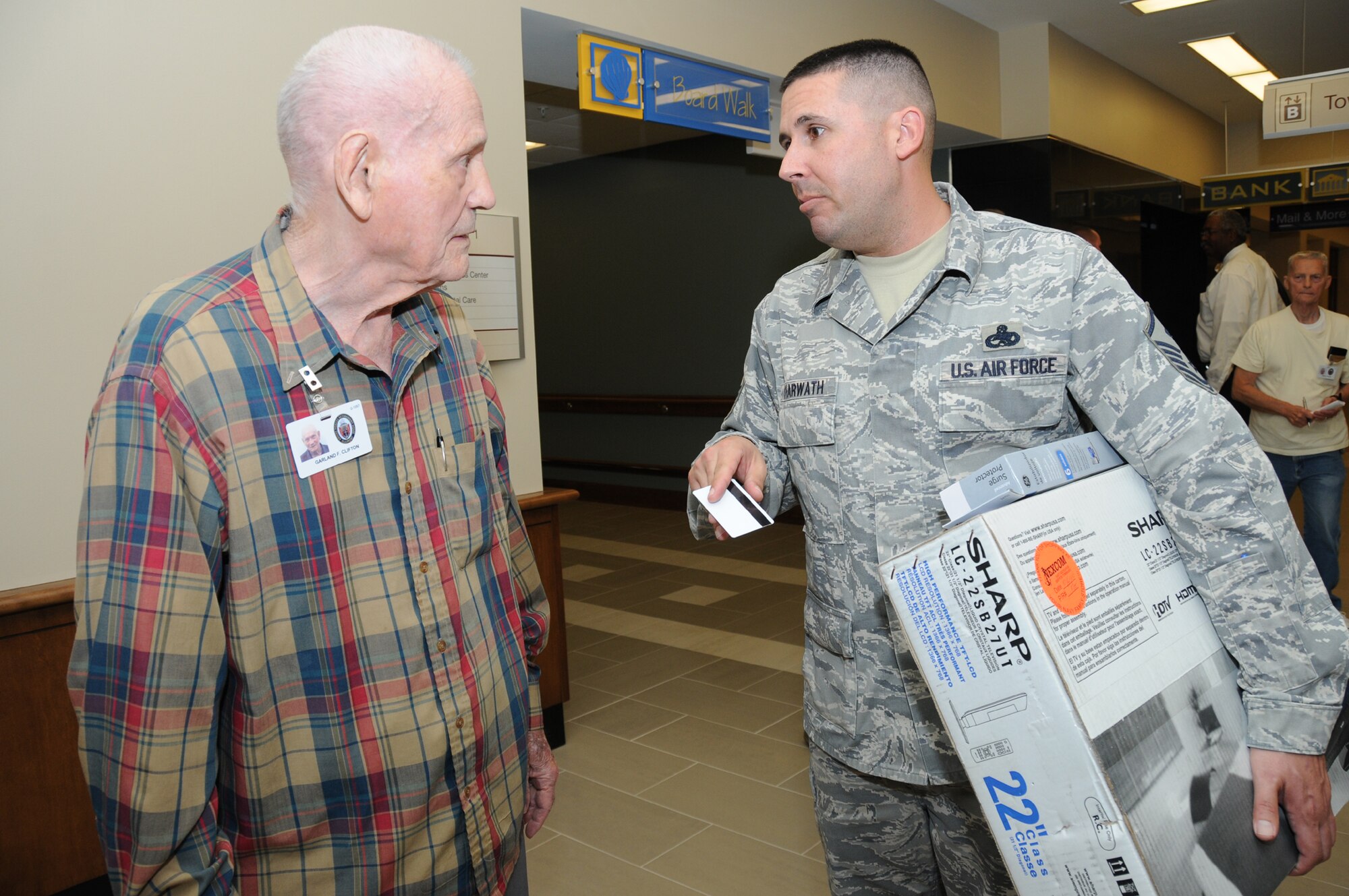 Master Sgt. Kevin Scharwath, 81st Logistics Readiness Squadron first sergeant, carries a television for Garland Clifton, an Air Force retiree who'll be living at the AFRH.  (U.S. Air Force photo by Kemberly Groue)