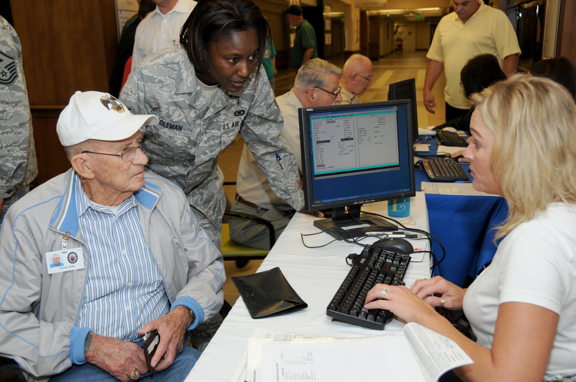 Navy retiree Floyd Astin is assisted by Staff Sgt. Kimberly Coleman, 81st Aerospace Medicine Squadron, as he signs up for cable access in his room at the AFRH with Lisa Millfelt, Cable One sales representative.  (U.S. Air Force photo by Kemberly Groue)