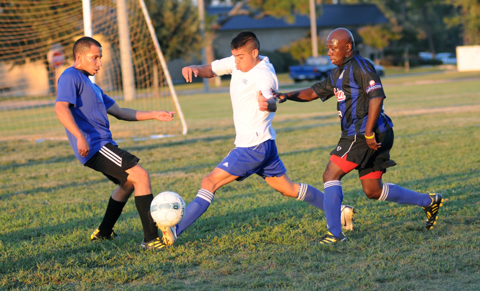 Dark Knights teammates Manuel Leon, left, and Fred Riley, right, surround the Gators’ John Cortes-Ramirez as he moves the ball down the field.  (U.S. Air Force photo by Kemberly Groue)