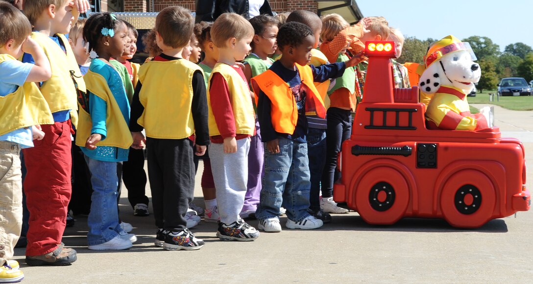 LANGLEY AIR FORCE BASE, Va. – Children from the National Security Agency Child Development Center, listen to fire safety tips from Sparky the fire dog Oct. 7. Base firefighters are teaching children about fire safety during Fire Prevention Week, Oct. 3-9.  Events and activities promoting fire safety and prevention culminate in a fire department open house. (U.S. Air Force photo/Staff Sgt. Tabitha Kuykendall) (released)