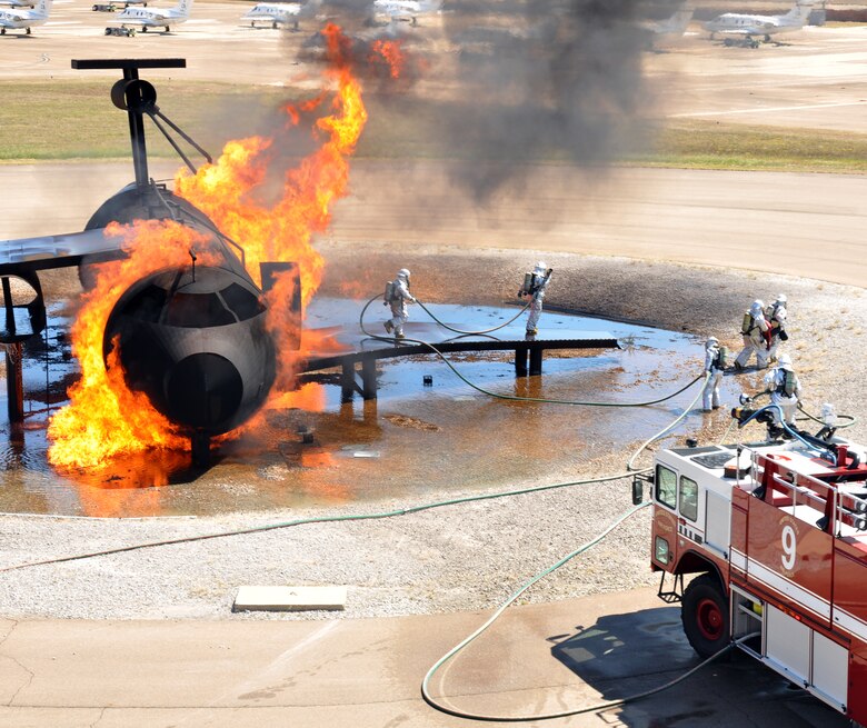 Columbus AFB Fire Fighters extinguish a controlled fire during a live fire demonstration Oct. 2 at the Fire Prevention Week Open House. (U.S. Air Force photo/Airman 1st Class Chase Hedrick).