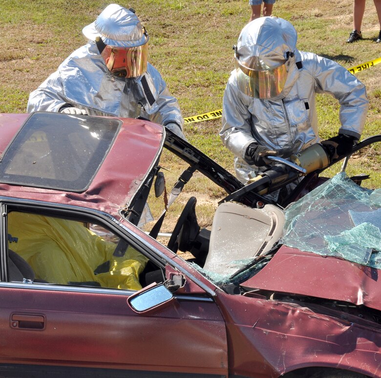 Senior Airman Jason Kislow and Senior Airman Scott
Romero, 14th Civil Engineer Squadron Fire Protection Services Flight, demonstrate a vehicle rescue extraction at the 2010 Fire Prevention Week Open House Oct. 2. (U.S. Air Force photo/Airman 1st Class Chase Hedrick).