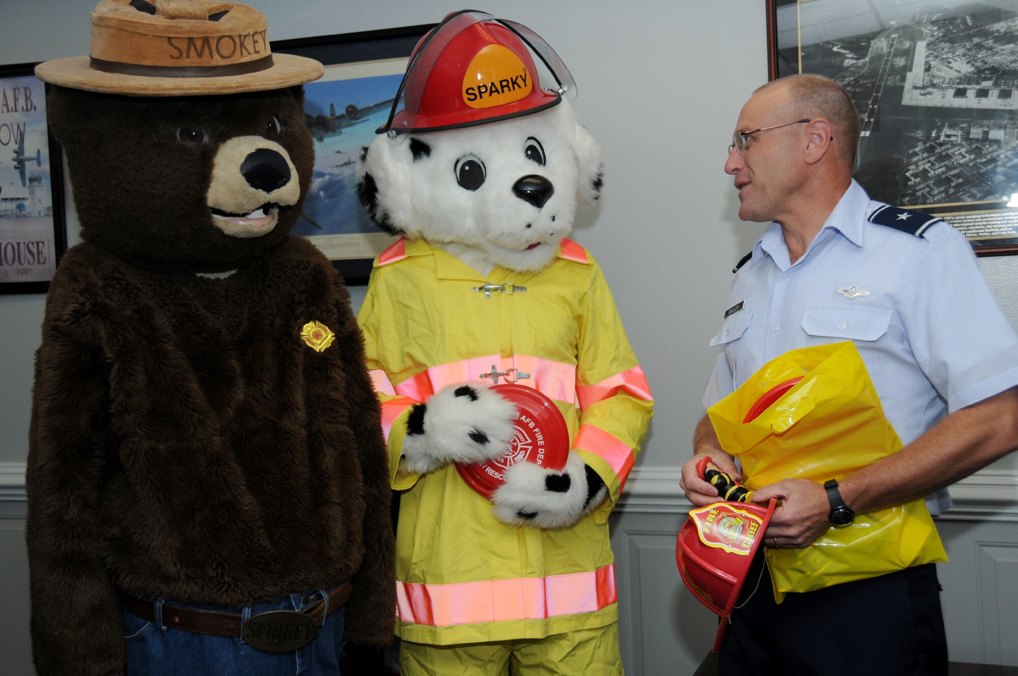 Smokey the Bear and Sparky the Fire Dog pay a visit to 81st Training Wing headquarters to have a word with Brig. Gen. Andrew Mueller, wing commander, to kick off Keesler’s observance of Fire PreventionWeek. Events and activities promoting fire safety and prevention end this weekend with Saturday’s fire department open house.  (U.S. Air Force photo by Kemberly Groue)