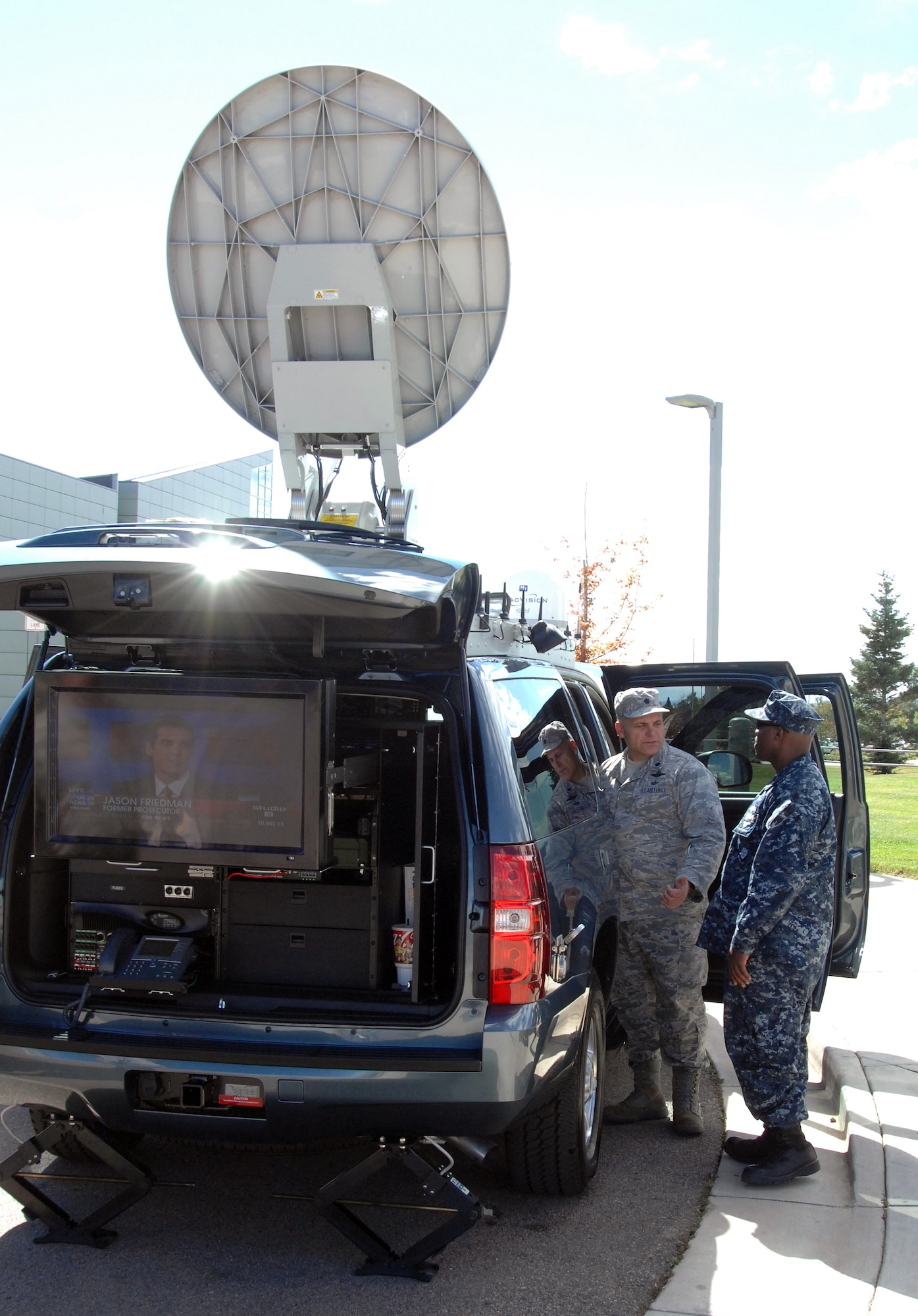 PETERSON AIR FORCE BASE, Colo. - Air Force Lt. Col. Joseph Kopacz receives a tour of the U.S. Northern Command Standing Joint Force Headquarters' new emergency response vehicle from Navy Chief Petty Officer Christopher Davis, NC-SJFHQ communications specialist during an open display of the vehicle Oct. 5. The customized 2010 Chevrolet Suburban sports an advanced communications package that provides the NC-SJFHQ with phone communications, secured computer networks, commercial internet and video teleconferencing in a mobile package small enough to be transported by a C-130. (U.S. Air Force photo/Staff Sgt. Thomas J. Doscher)
