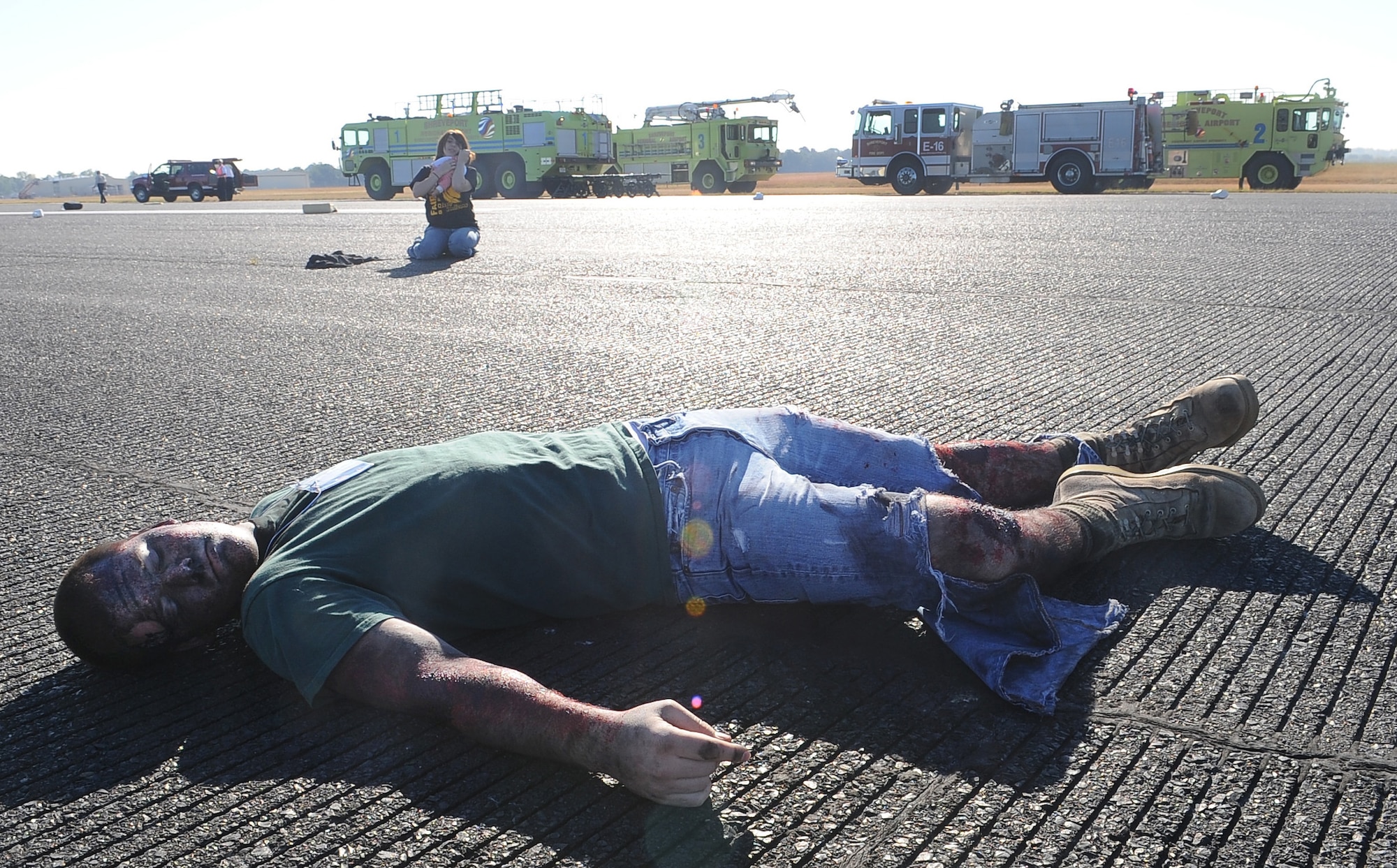 BARKSDALE AIR FORCE BASE, La. -- A victim from a simulated plane crash lies severely wounded amongst other victims during a full-scale disaster drill at the Shreveport Regional airport Oct. 6. More than 60 simulated victims were either listed as deceased or injured and Bossier City, Shreveport and Caddo law enforcement, fire department and emergency medical technicians arrived on scene to assist. The exercise provided training and an opportunity for Barksdale Airmen to work with other emergency units.  (U.S. Air Force photo/Senior Airman Amber Ashcraft) (RELEASED)