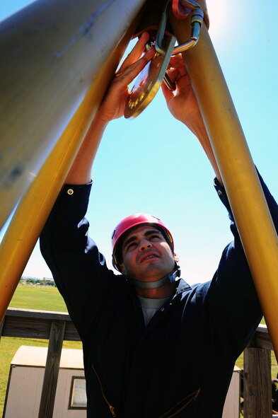 DYESS AIR FORCE BASE, Texas -- Airman 1st Class Anthony Guajardo, 7th Civil Engineer firefighter, from Dyess Air Force Base, Texas assembles a tripod used for propelling and hauling, Oct. 6. The tripod is checked three times for safety before it is used to propel or haul anyone. (U.S. Air Force photo/ Senior Airman Domonique Washington) 