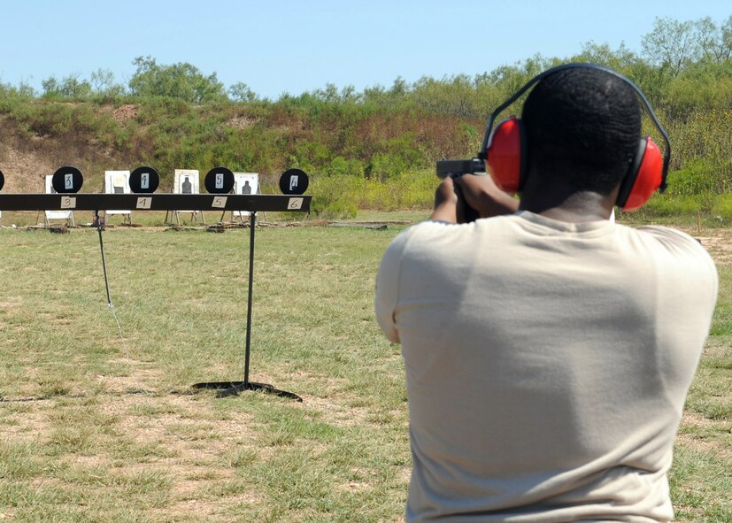 ABILENE, Texas-- Senior Airman Roderick Jackson, 7th Security Forces Squadron, shoots a target during the 3rd annual Gun-N-Hoses Competition at the Warren Dodson Training Facility here, Oct. 2. The competition is a way for Dyess Airmen to interact with the Abilene community. Abilene firefighters, police officers and Dyess’ Security Forces Airmen competed against one another in a friendly competition of skills that included a hose pull, dummy drag and pistol shooting. (U.S. Air Force photo/ Senior Airman Felicia Juenke)