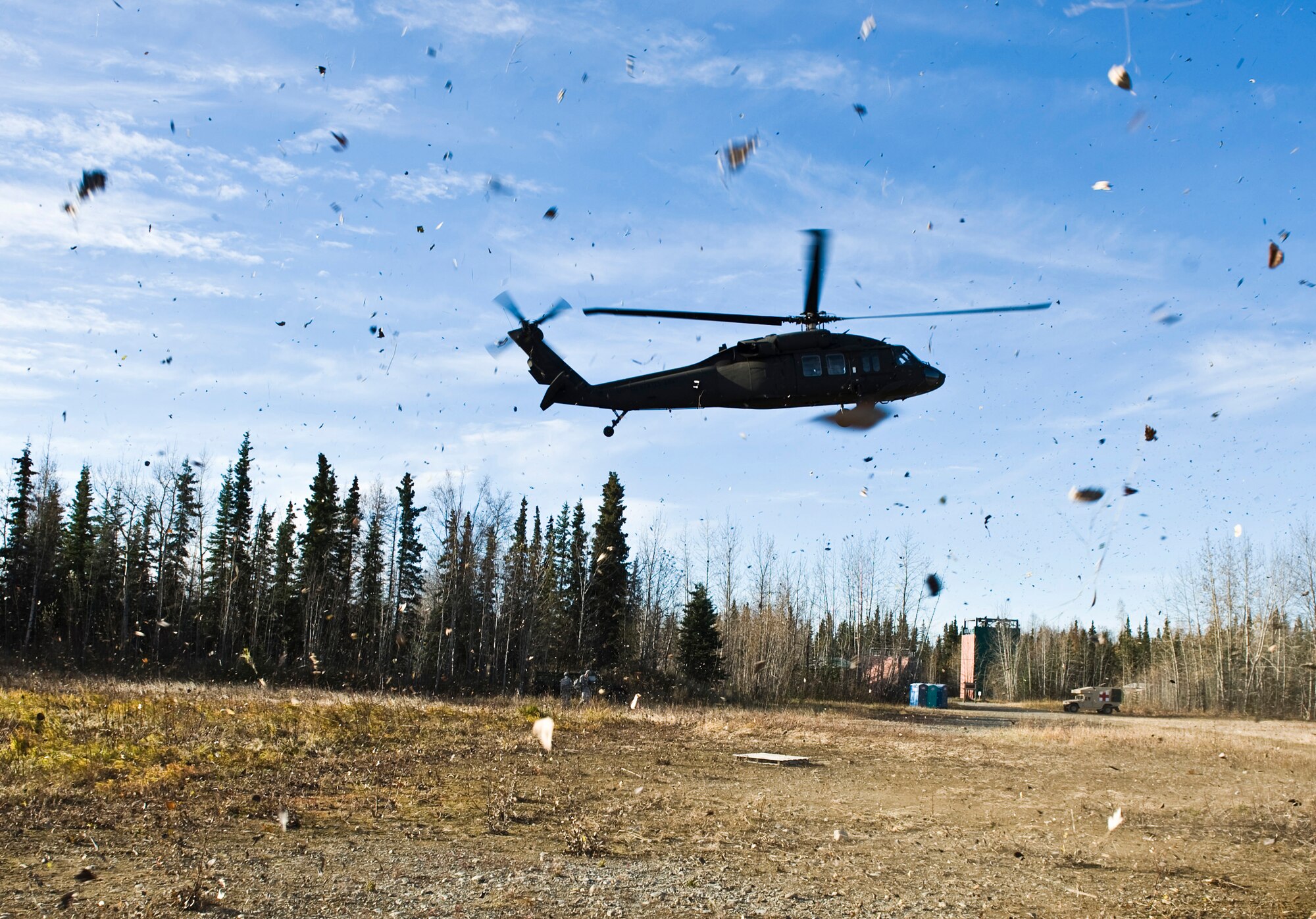 JOINT BASE ELMENDORF-RICHARDSON, Alaska -- An Army UH-60 Black Hawk hovers low so that an M119 105 mm howitzer can be sling loaded to it Oct. 5. Soldiers of the Alpha Battery from the 2nd Battalion of the 377th Parachute Field Artillery Regiment simulated a two-gun raid, firing into "enemy territory," as part of some mission-ready training. (U.S. Air Force photo/Airman 1st Class Christopher Gross)  