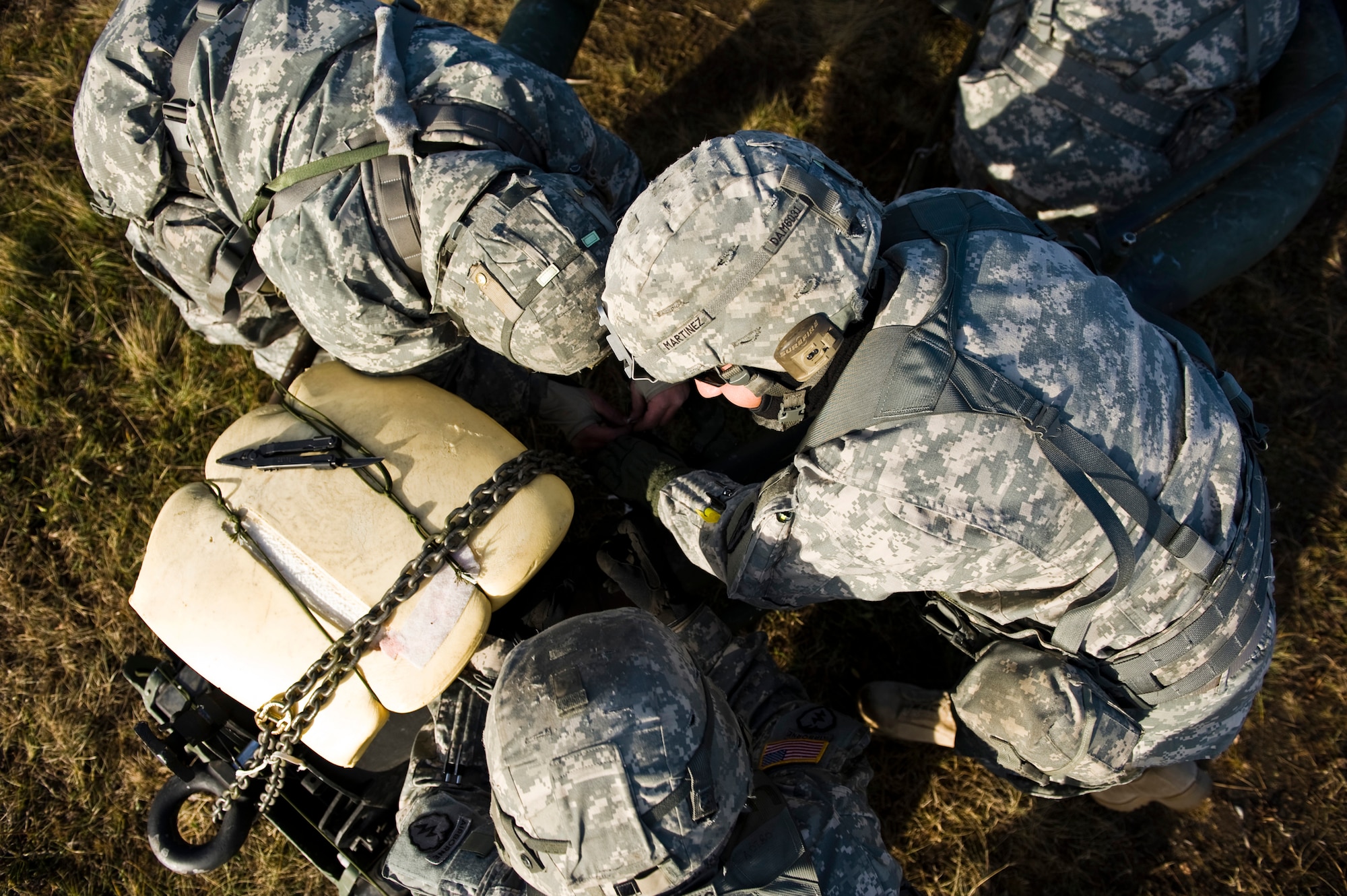 JOINT BASE ELMENDORF-RICHARDSON, Alaska -- Soldiers from the 1st Section of the Alpha Battery from the 2nd Battalion of the 377th Parachute Field Artillery Regiment work together to set up an M119 105 mm howitzer Oct. 5. Members of the 2-377th PFAR simulated a two-gun raid, firing into "enemy territory," as part of some mission-ready training. They used M119 105 mm howitzers which were sling loaded to the Black Hawk as part of the training. (U.S. Air Force photo/Airman 1st Class Christopher Gross)  