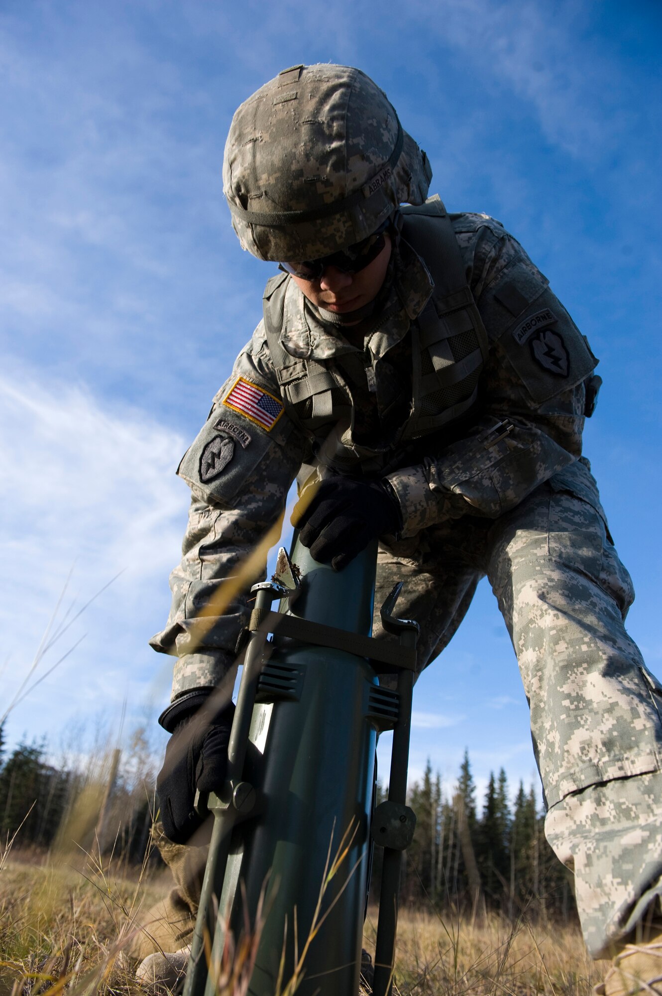 JOINT BASE ELMENDORF-RICHARDSON, Alaska -- Spc. Jessie Abrams of the 1st Section of the Alpha Battery from the 2nd Battalion of the 377th Parachute Field Artillery Regiment sets up a collimator, used for sighting in a howitzer, Oct. 5. Members of the 2-377th PFAR simulated a two-gun raid, firing into "enemy territory," as part of some mission-ready training. They used M119 105 mm howitzers which were sling loaded to the Black Hawk as part of the training. (U.S. Air Force photo/Airman 1st Class Christopher Gross)  