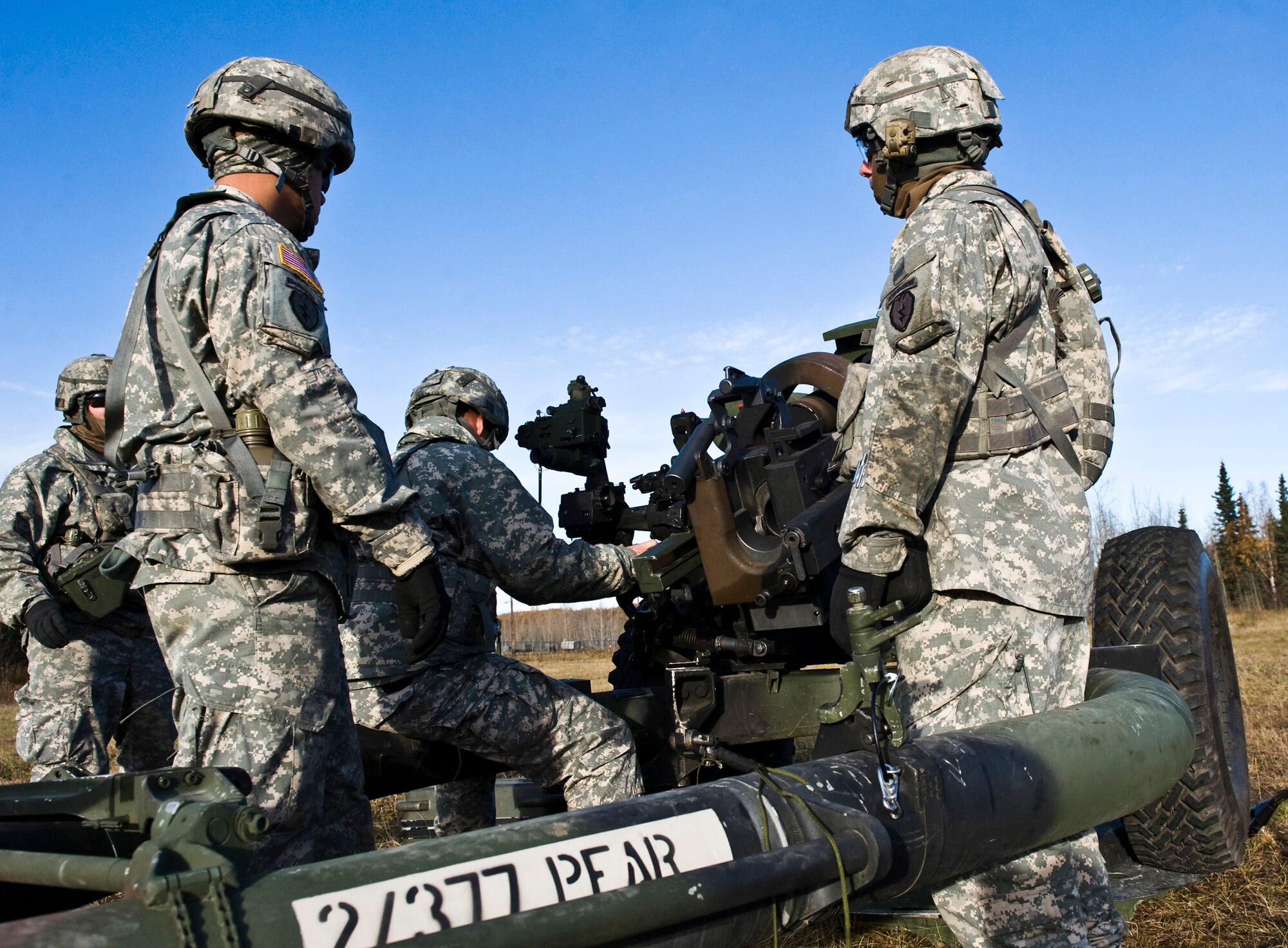 JOINT BASE ELMENDORF-RICHARDSON, Alaska -- Soldiers from the 1st Section of the Alpha Battery from the 2nd Battalion of the 377th Parachute Field Artillery Regiment work together simulating firing an M119 105 mm howitzer Oct. 5. Members of the 2-377th PFAR simulated a two-gun raid, firing into "enemy territory," as part of some mission-ready training. They used M119 105 mm howitzers which were sling loaded to the Black Hawk as part of the training. (U.S. Air Force photo/Airman 1st Class Christopher Gross)  