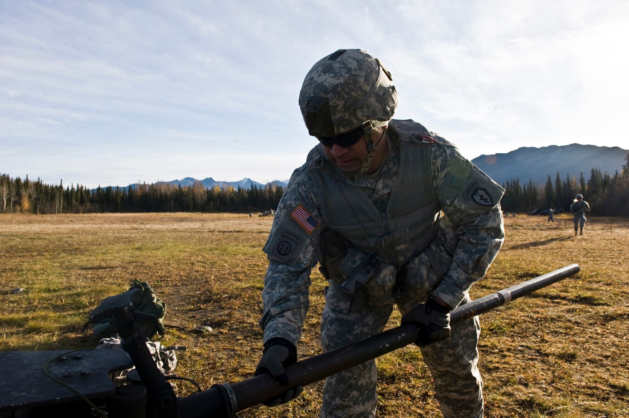 JOINT BASE ELMENDORF-RICHARDSON, Alaska -- A Soldier from A Battery from the 2nd Battalion of the 377th Parachute Field Artillery Regiment works with his section on setting up an M119 105 mm howitzer Oct. 5. Members of the 2-377th PFAR simulated a two-gun raid, firing into "enemy territory," as part of some mission-ready training. They used 105 mm howitzers which were sling loaded to the Black Hawk as part of the training. (U.S. Air Force photo/Airman 1st Class Christopher Gross)  