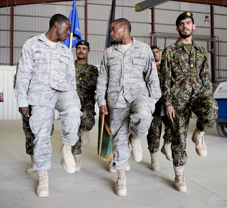 Members of the 451st Air Expeditionary Wing Honor Guard train Afghan Airmen how to march for ceremonies Oct. 3, 2010, at Kandahar Airfield, Afghanistan. The 451st AEW Honor Guard worked with the Afghans to help them prepare their own Honor Guard for a ceremony marking the one year anniversary of the Kandahar Air Wing. (U.S. Air Force photo by Tech. Sgt. Chad Chisholm)
