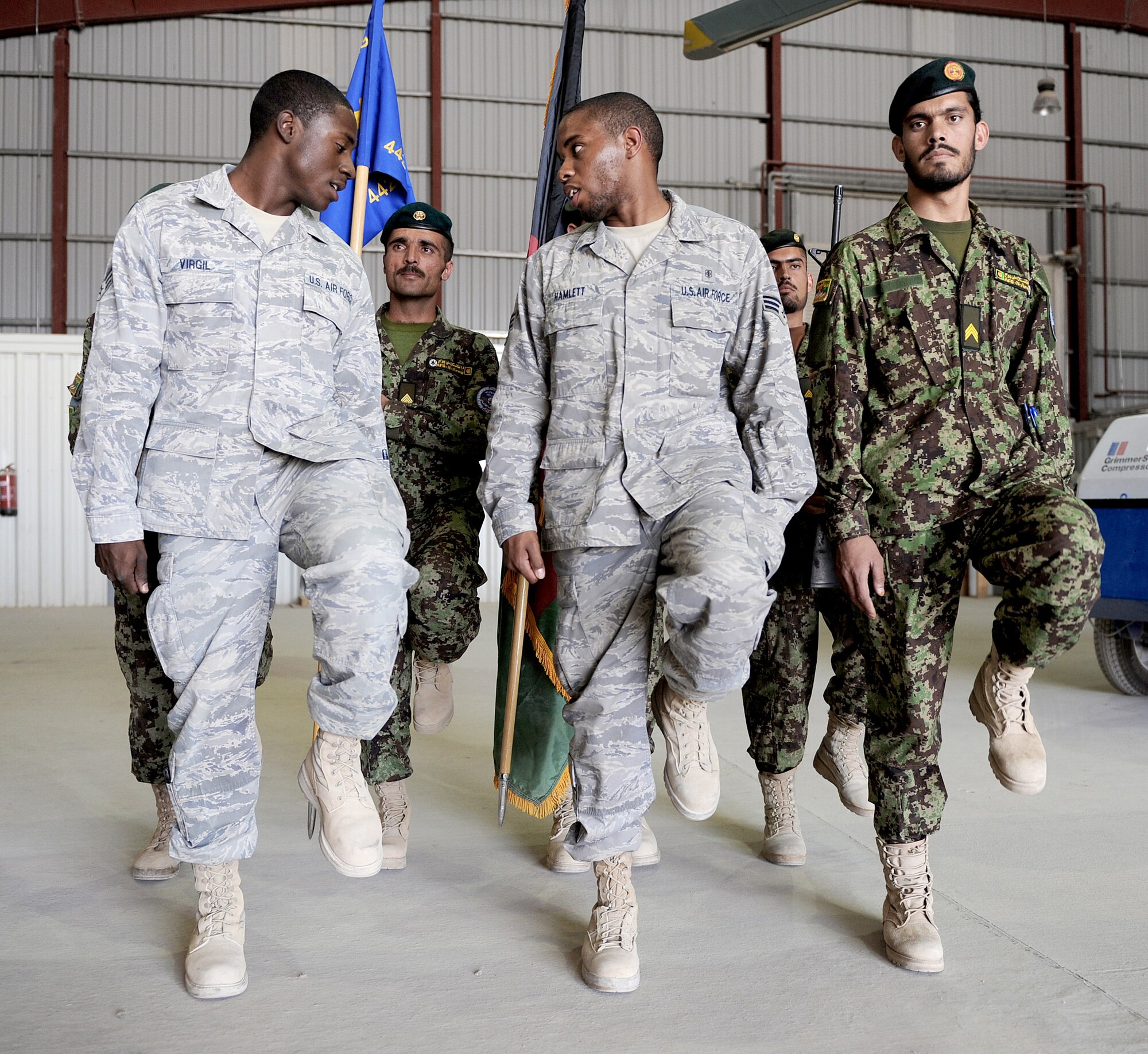 Members of the 451st Air Expeditionary Wing Honor Guard train Afghan Airmen how to march for ceremonies Oct. 3, 2010, at Kandahar Airfield, Afghanistan. The 451st AEW Honor Guard worked with the Afghans to help them prepare their own Honor Guard for a ceremony marking the one year anniversary of the Kandahar Air Wing. (U.S. Air Force photo by Tech. Sgt. Chad Chisholm)