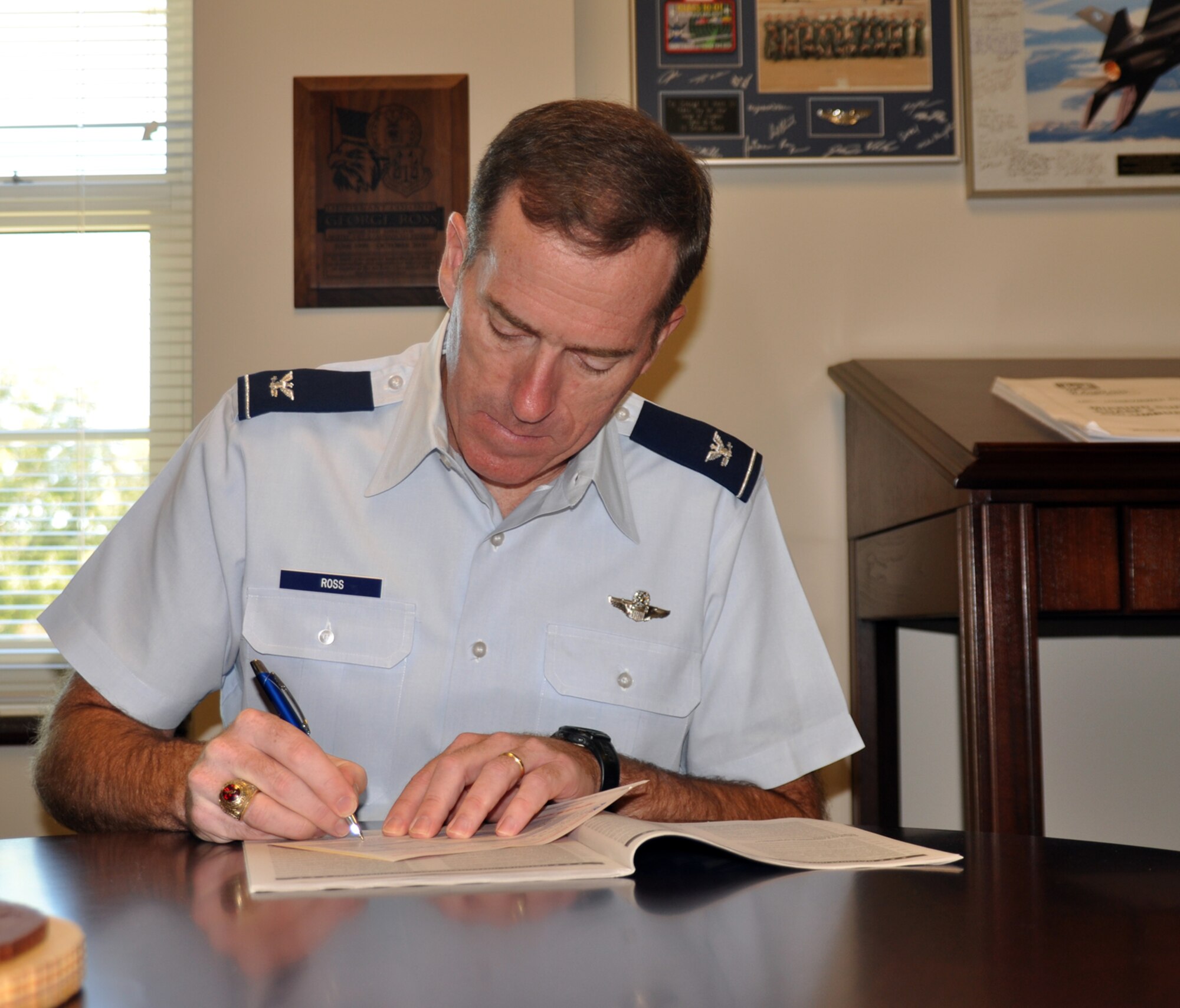 Col. George Ross, 14th Flying Training Wing vice commander, signs a Combined Federal Campaign pledge form Oct. 4. The CFC brings together federal employees throughout the United States and abroad to take part in the largest and most successful workplace charity campaign in the United States. This year the campaign runs from Oct. 4 to Nov. 15. (U.S. Air Force photo/Airman 1st Class Chase Hedrick). 