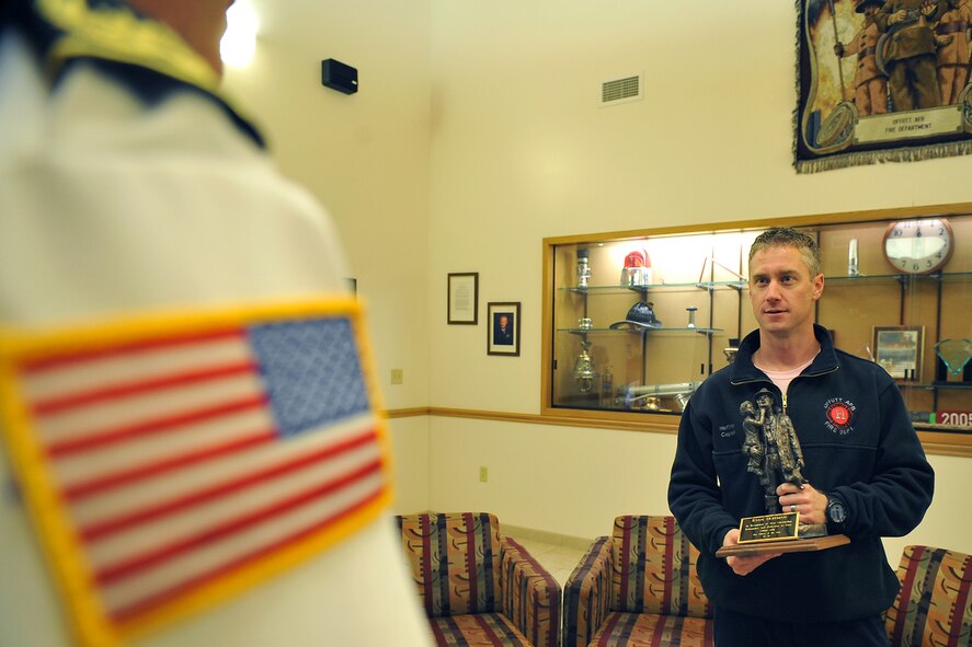 OFFUTT AIR FORCE BASE, Neb. -- Todd Kiesel, assistant fire chief with the 55th Civil Engineering Squadron, talks with Ryan Hoffman, another squadron member, after being honored as fire officer of the year during a ceremony in the fire station Oct. 7. Each year during Fire Prevention Week, Offutt names its fire fighter and fire officer of the year.  U.S. Air Force photo by Charles Haymond