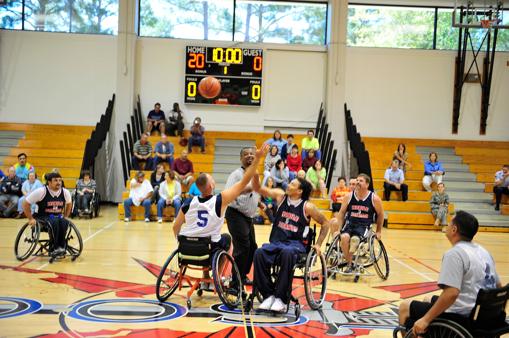 U.S. Air Force Master Sgt.  Michael Sullivan (left), 19th Special Operations Squadron, goes up for a jump ball against Kenny Lee of the Mobile Patriots during the fifth annual Wheelchair Basketball Exhibition Game at the Aderholt Fitness Center at Hurlburt Field, Fla., Oct. 4, 2010. The Air Commandos hosted the Mobile Patriots, a Gulf Coast division three National Wheelchair Basketball Association team, in recognition of National Disability Employment Awareness month. (DoD photo by U.S. Air Force Staff Sgt. Stephanie Jacobs/RELEASED)
