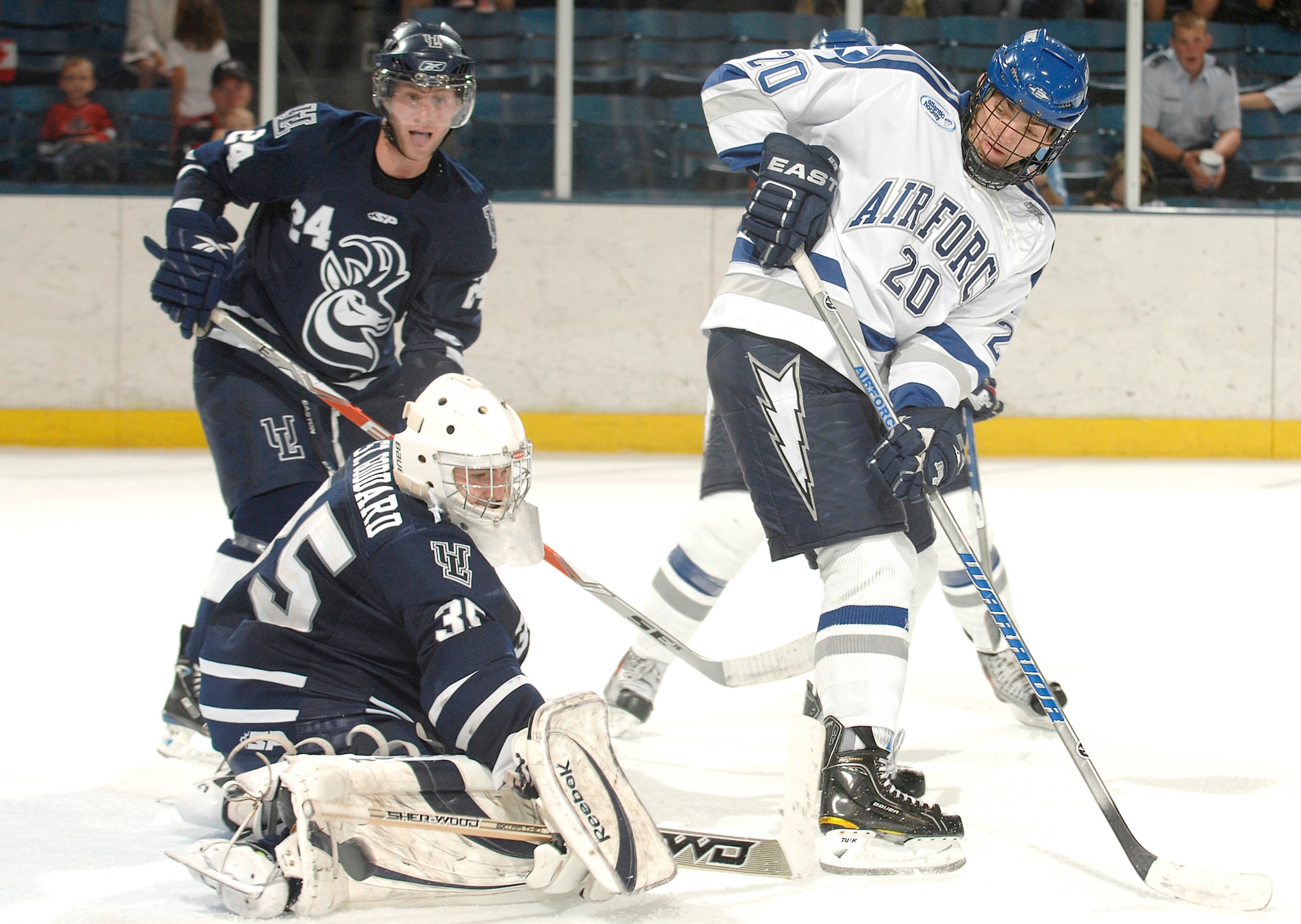 Air Force freshman Tony Thomas attempts a back-hander in front of the goal during a hockey exhibition game against the University of Lethbridge from Alberta, Canada,  Oct. 4, 2010, at the U.S. Air Force Academy's Cadet Ice Arena, in Colorado Springs, Colo.    Air Force defeated the Pronghorns 4-3 in overtime. (U.S. Air Force photo/Mike Kaplan)