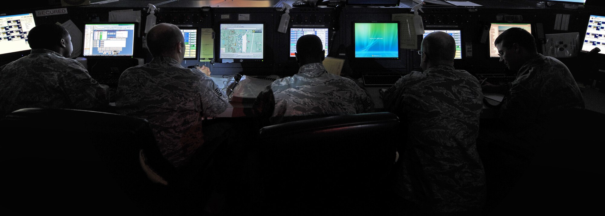 WHITEMAN AIR FORCE BASE, Mo. - Members of the 509th Bomb Wing Command Post review multiple computers screens on the main console, controlling base functions and communication Oct. 5. Whiteman's Command Post was named Best Large Command Post in the Air Force for 2009. (U.S. Air Force photo by Senior Airman Carlin Leslie)
