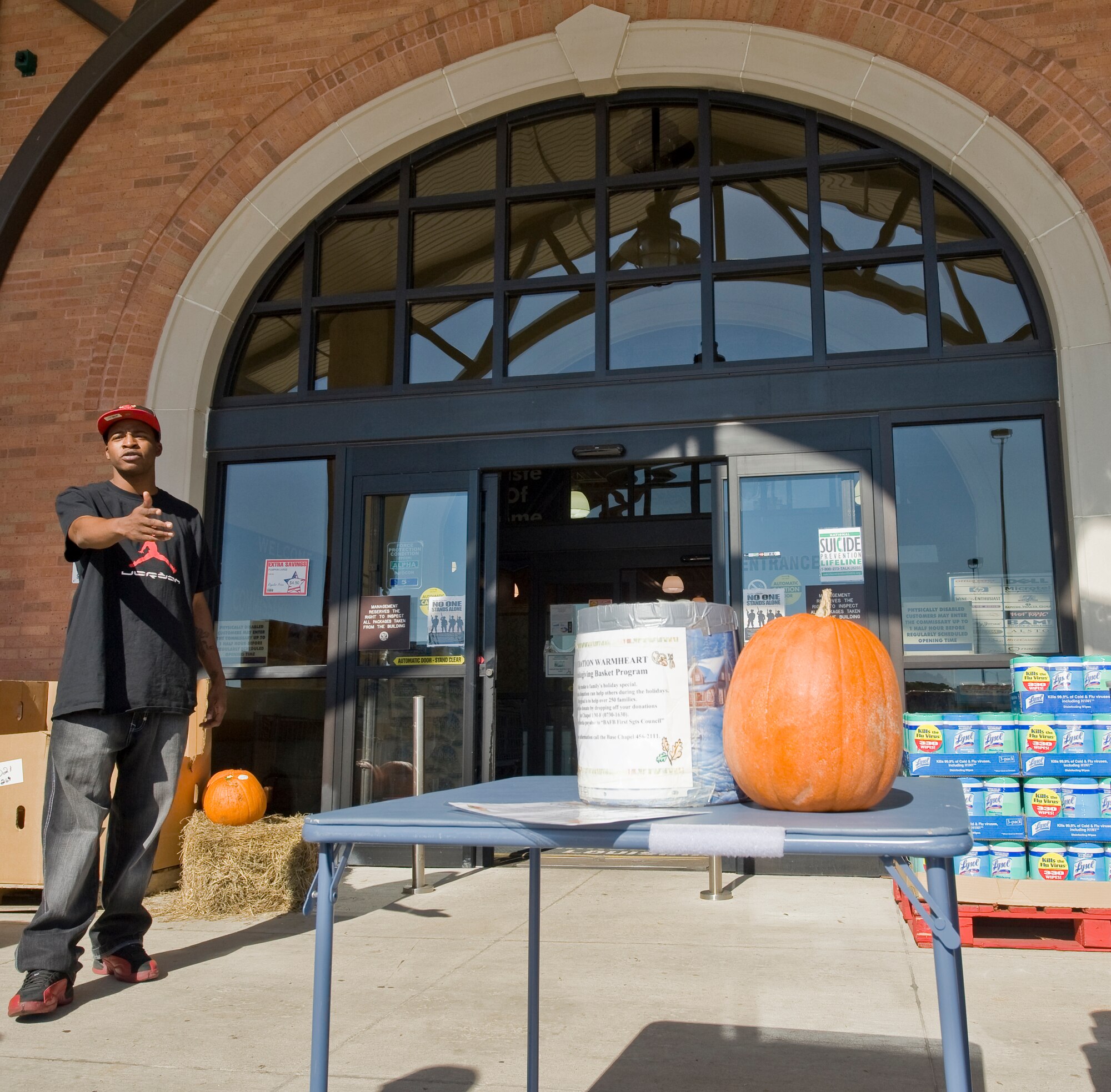 BARKSDALE AIR FORCE BASE, La. -- Staff Sgt. Richard Hicks, 2nd Security Forces Squadron, asks for donations during Operation Warmheart outside the Commissary Oct. 6. Operation Warmheart is a program that provides for Airmen and their families who may need financial help during the holidays. (U.S. Air Force photo/Senior Airman Chad Warren)