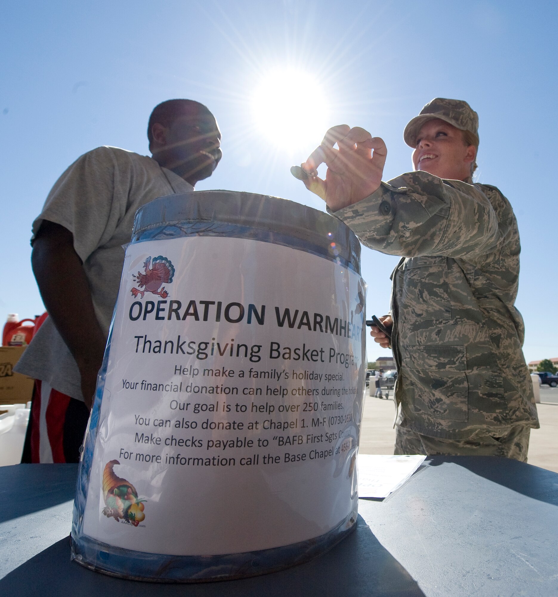 BARKSDALE AIR FORCE BASE, La. -- Senior Airman Brandi Rae, 2nd Logistics Readiness Squadron, donates money to Operation Warmheart outside the Commissary Oct. 6. Operation Warmheart is a program that provides for Airmen and their families who may need financial help during the holidays. (U.S. Air Force photo/Senior Airman Chad Warren)