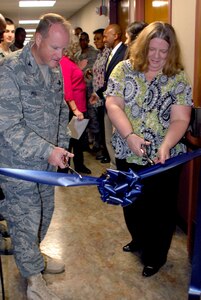 Col. Scott Peel, 902nd Mission Support Group commander, and Pamela Arserio, 902nd Comptroller Squadron lead financial analyst, cut the cerimonial ribbon opening the new finance center Oct. 7. The newly renovated finance center is located on the 2nd floor of Bldg. 399. 
(U.S. Air Force photo/Amn Alexis Siekert)