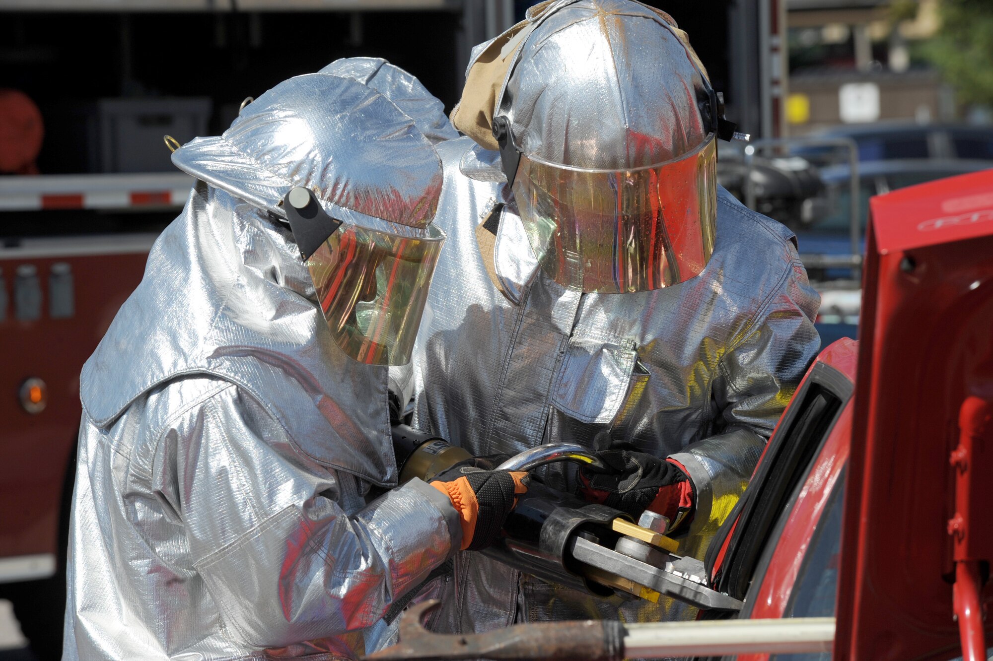 Firefighters from McConnell Fire and Emergency Services use the Jaws of Life to cut into a car during a vehicle accident response demonstration during the Fire Prevention Week Extravaganza, Oct. 2, 2010, McConnell Air Force Base, Kan.  The fire department hosted the sixth annual Fire Prevention Extravaganza at McConnell family housing which included a parade, games, safety displays and a rescue response demonstration.  “Smoke Alarms: A Sound You Can Live With!” is the theme for the nationwide 2010 Fire Prevention Week campaign, which runs from Oct. 3 through 9.   (U.S. Air Force photo/Staff Sgt. Dallas Edwards)