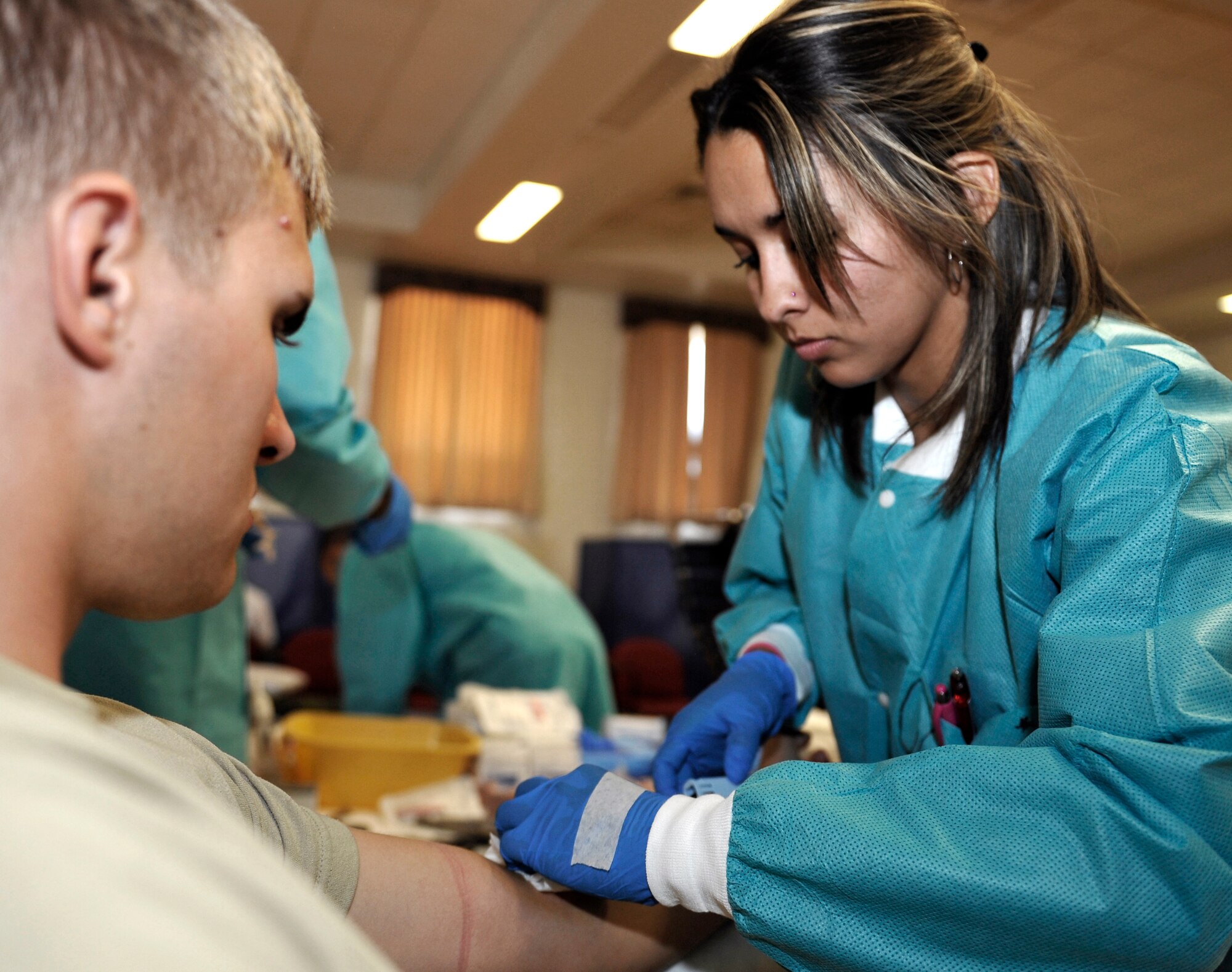 HOLLOMAN AIR FORCE BASE, N.M. -- Airman 1st Class Jason Tymkowiche, 849th Aircraft Maintenance Squadron, gets his blood drawn by Angelica Chavez, a phlebotomist from the Blood Donor Center at William Beaumont Army Medical Center in El Paso, Texas, during the Armed Services Blood Drive Oct. 4, 2010. The blood drive was sponsored by the Blood Donor Center at WBAMC. Members from the WBAMC travel to military installations throughout the southwest region of the U.S. to collect blood donations from military members, their families and civilians with access to the different installations. (U.S. Air Force photo by Senior Airman Veronica Stamps / Released)