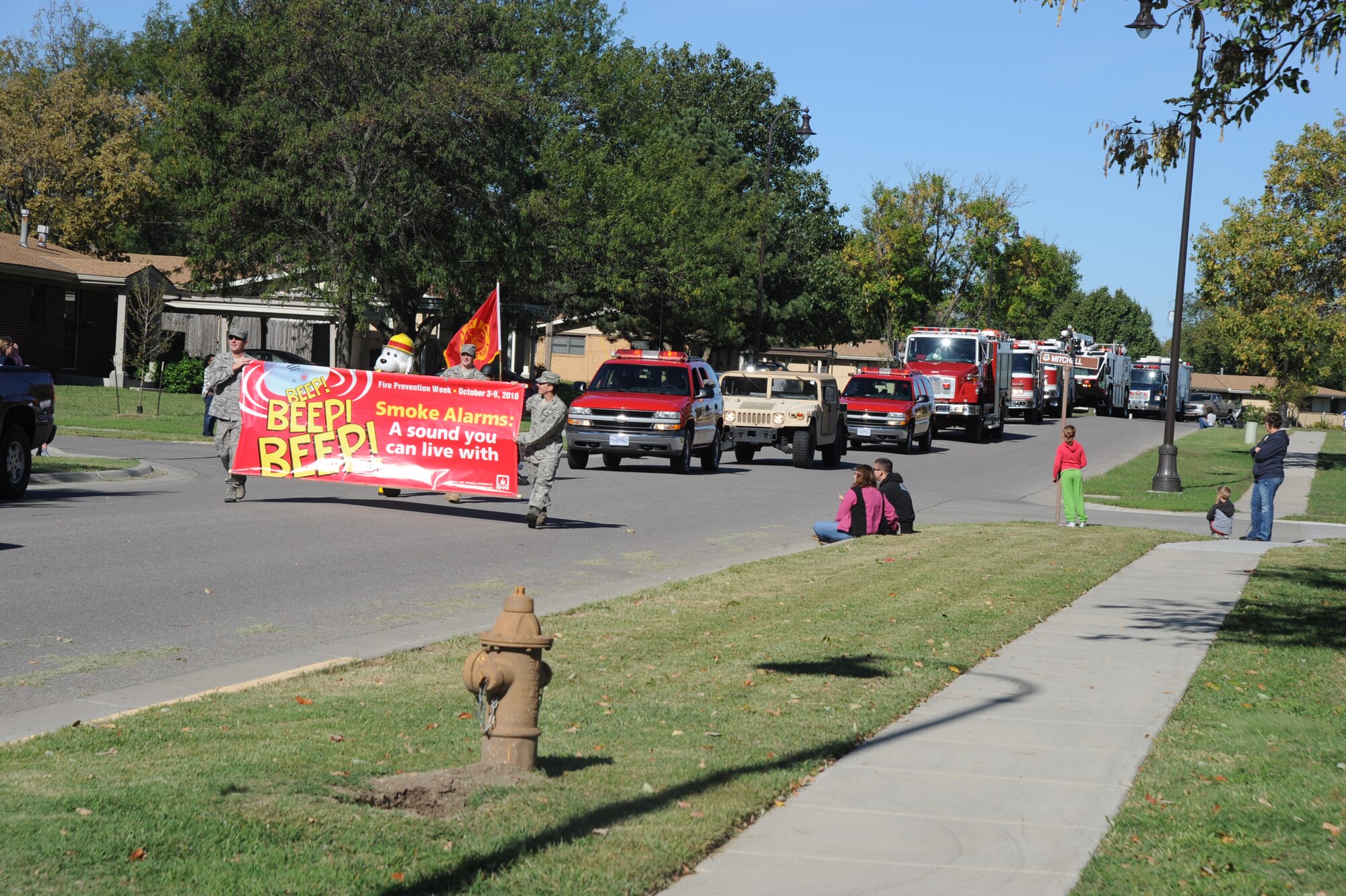 Members of the McConnell Fire and Emergency Services held a parade at McConnell family housing to kick off Fire Prevention Week, Oct. 2, 2010, McConnell Air Force Base Kan.  The fire department hosted the sixth annual Fire Prevention Extravaganza at McConnell family housing which included a parade, games, safety displays and rescue response demonstration.  “Smoke Alarms: A Sound You Can Live With!” is the theme for the nationwide 2010 Fire Prevention Week campaign, which runs from Oct. 3 through 9.   (U.S. Air Force photo/Staff Sgt. Dallas Edwards)