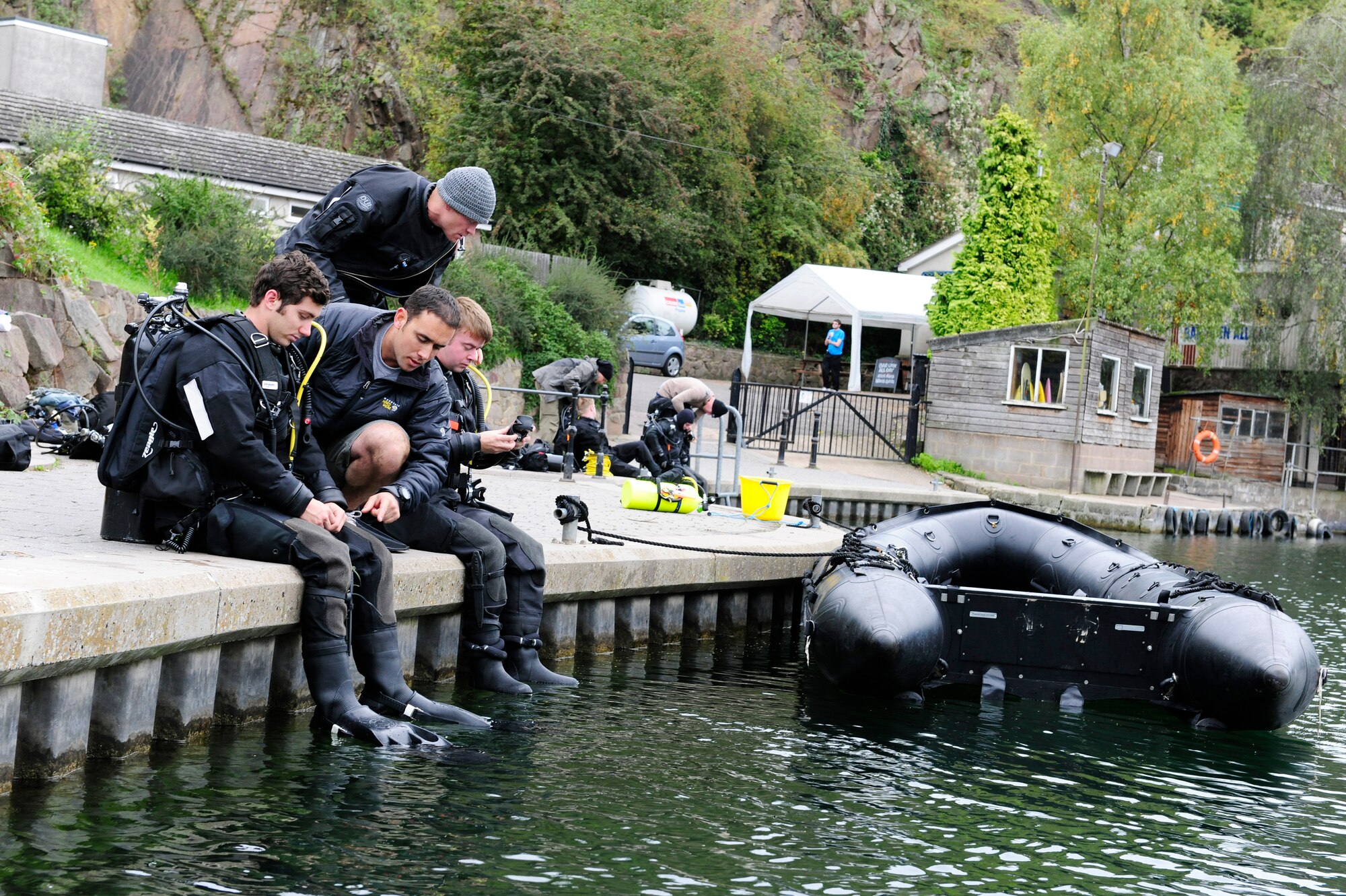 STONEY COVE, England – Pararescuemen from the 56th Rescue Squadron perform equipment checks before entering the water for subsurface search, rescue and recovery training Oct. 5. Pararescumen wear dry suits when training for real-world missions. Dry suits allow protection from exposure to contaminants while in the water.  (U.S. Air Force photo/Airman 1st Class Lausanne Morgan)